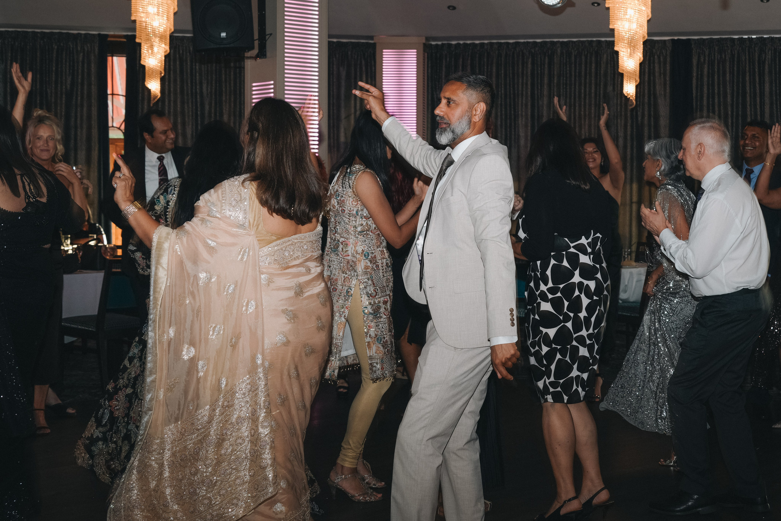 Guests dancing joyfully during a wedding reception in Solihull