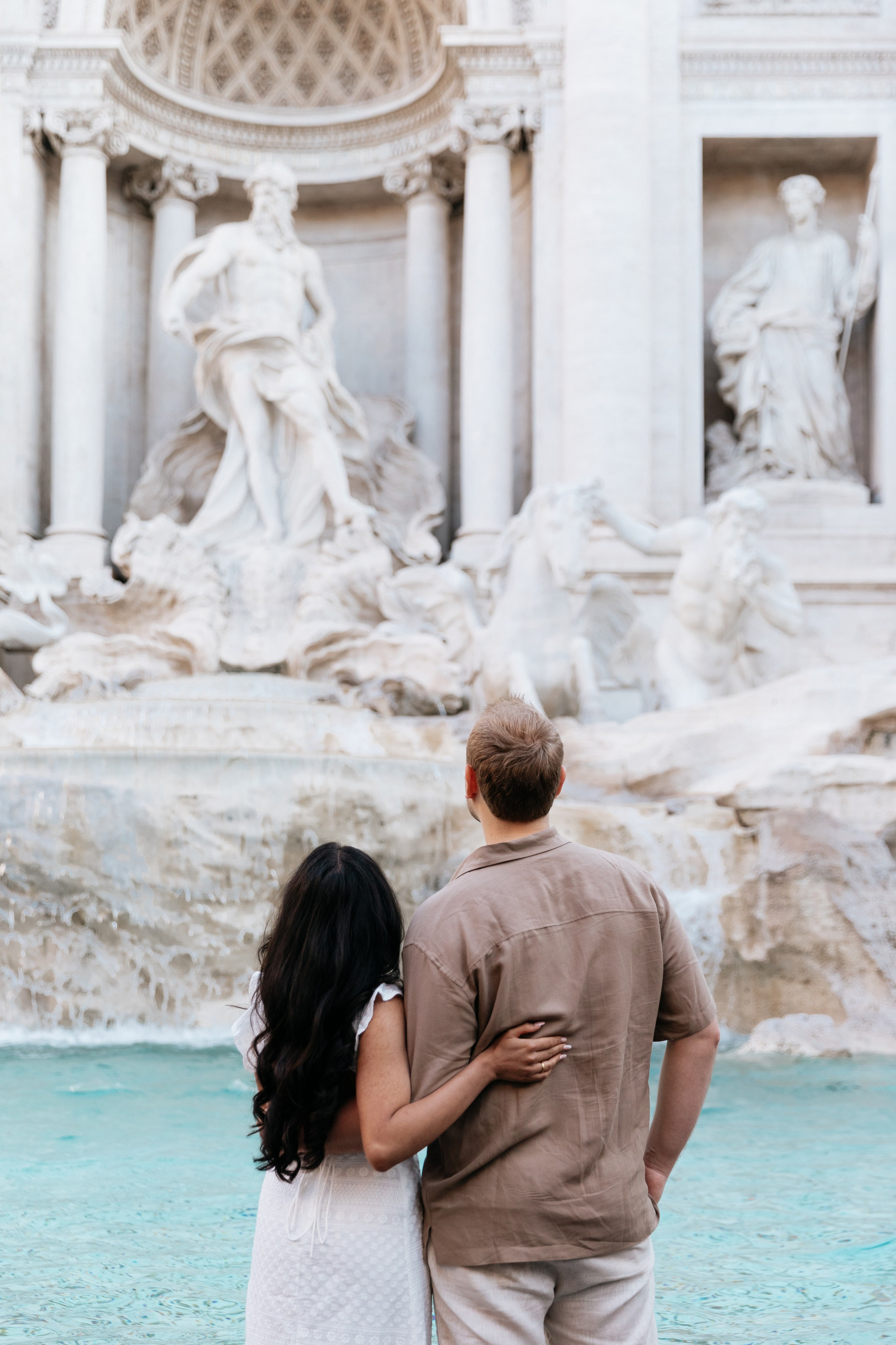 THREE COINS IN THE TREVI FOUNTAIN. Photographer in Rome