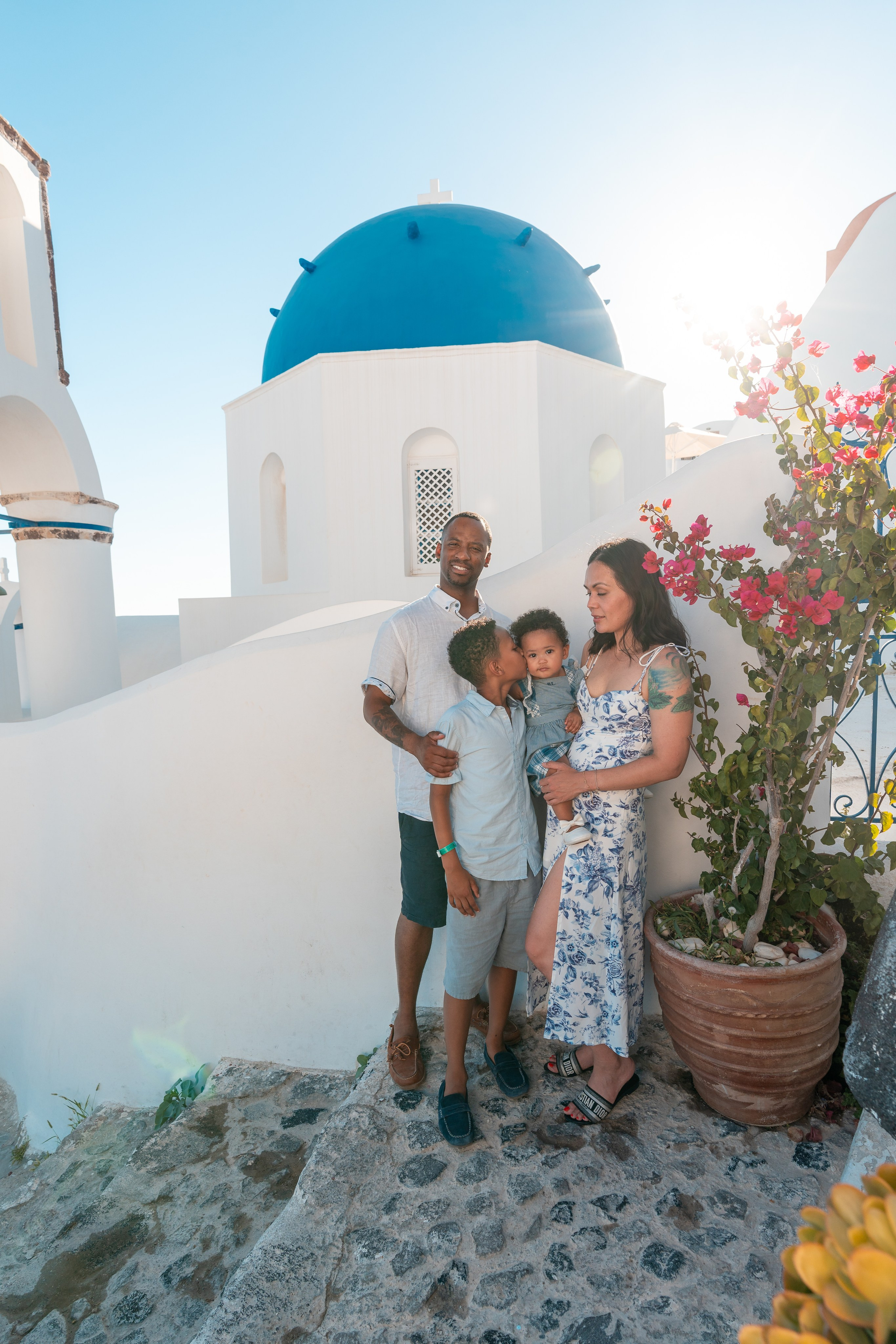 "Book your Santorini family photoshoot today! Whether at the blue domes of Oia, the cliffs of Imerovigli, or a secret beach, we create breathtaking memories to last a lifetime."