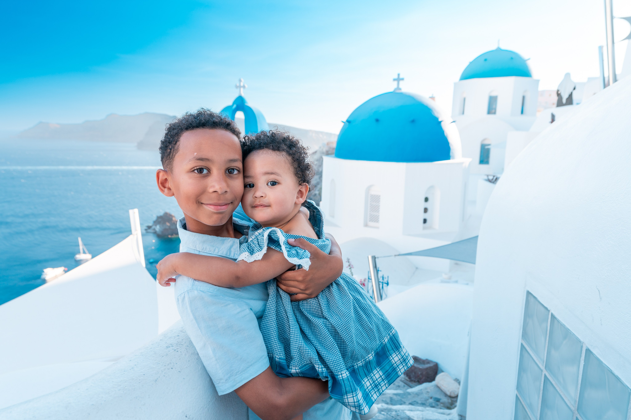 "Make your Santorini vacation unforgettable with a professional family photoshoot. Whether on the beach or in charming village streets, we’ll capture your most precious moments."