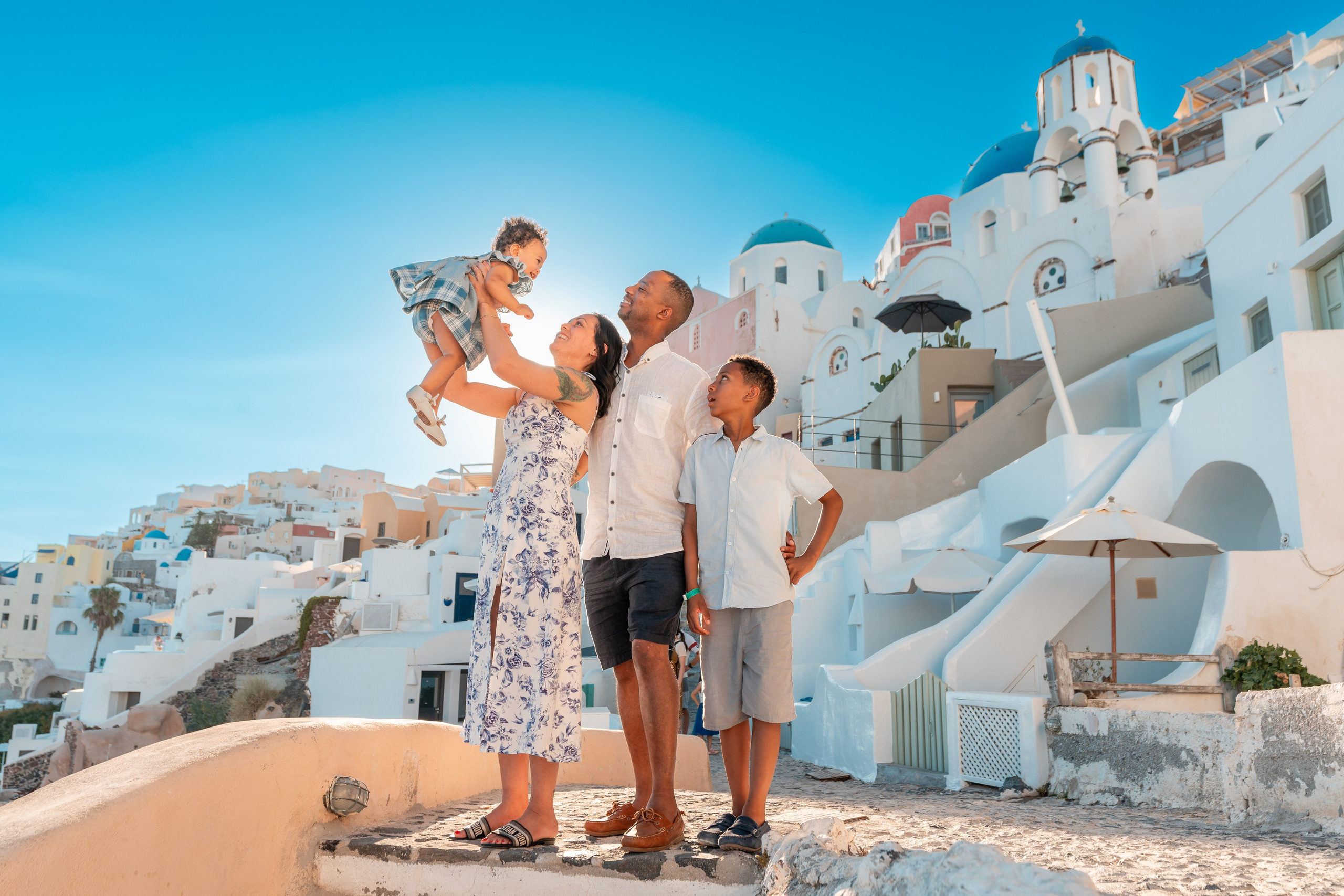 "Book your Santorini family photoshoot today! Whether at the blue domes of Oia, the cliffs of Imerovigli, or a secret beach, we create breathtaking memories to last a lifetime."