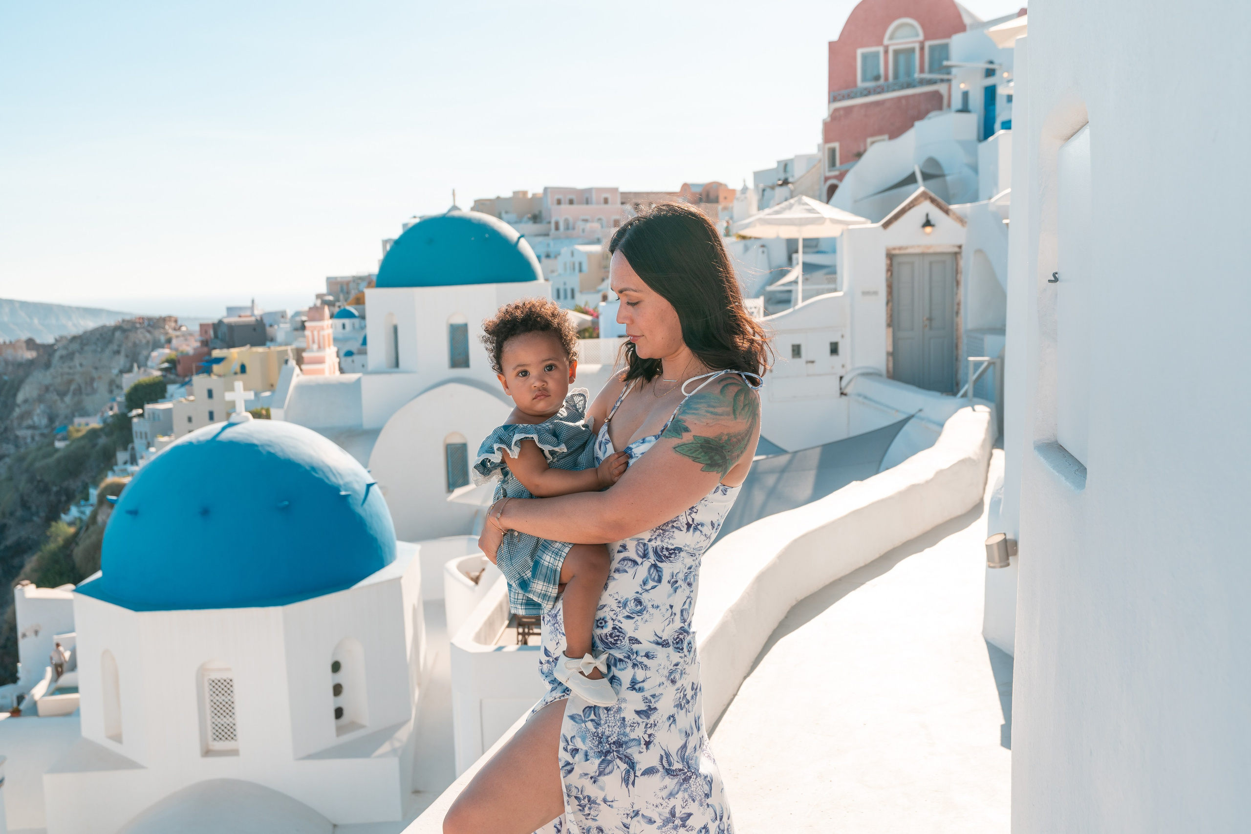 "Santorini family photography at its best! Book a professional photoshoot and enjoy stunning portraits in the most picturesque locations, from Oia’s blue domes to hidden coastal gems."