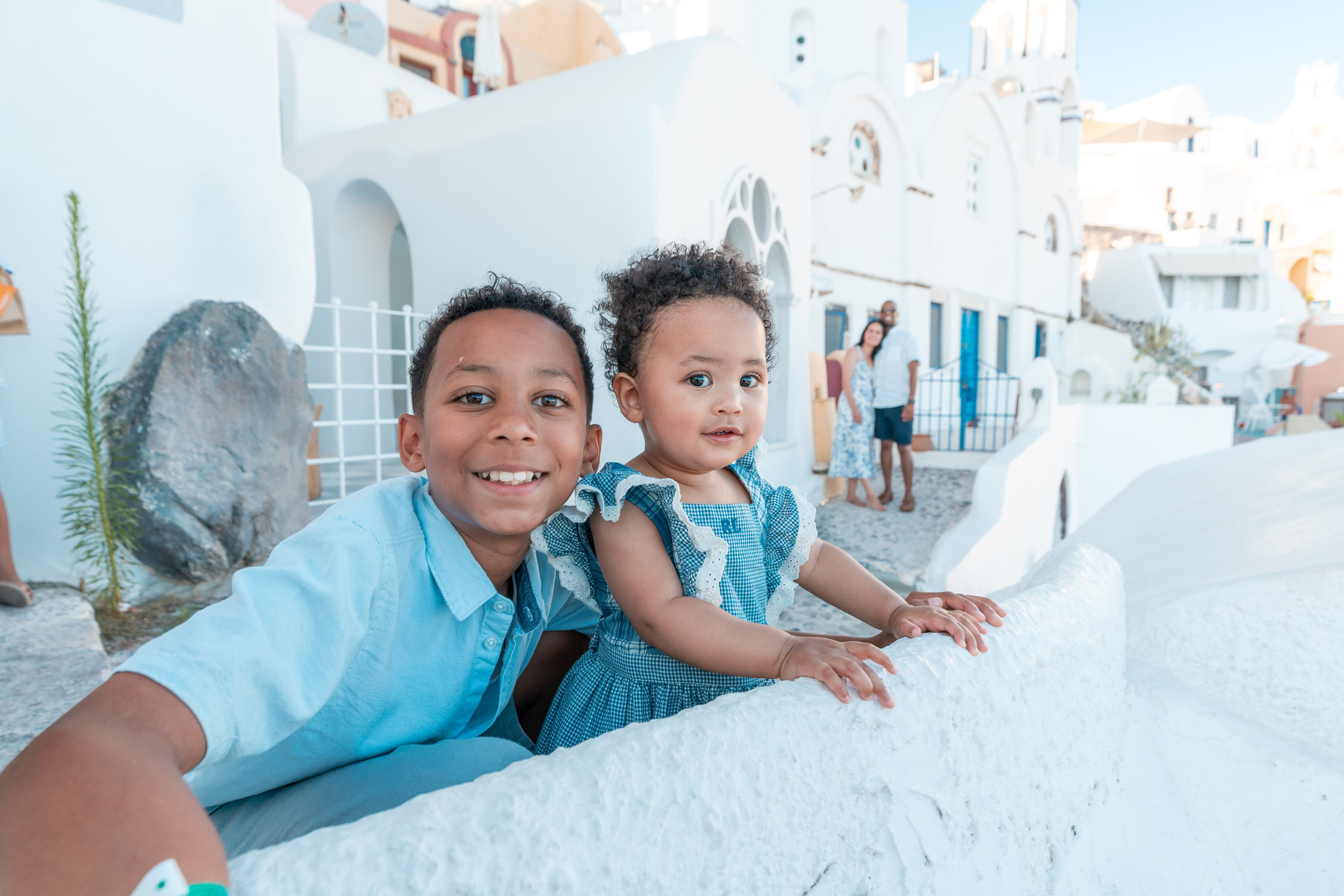 "Book your Santorini family photoshoot today! Whether at the blue domes of Oia, the cliffs of Imerovigli, or a secret beach, we create breathtaking memories to last a lifetime."
