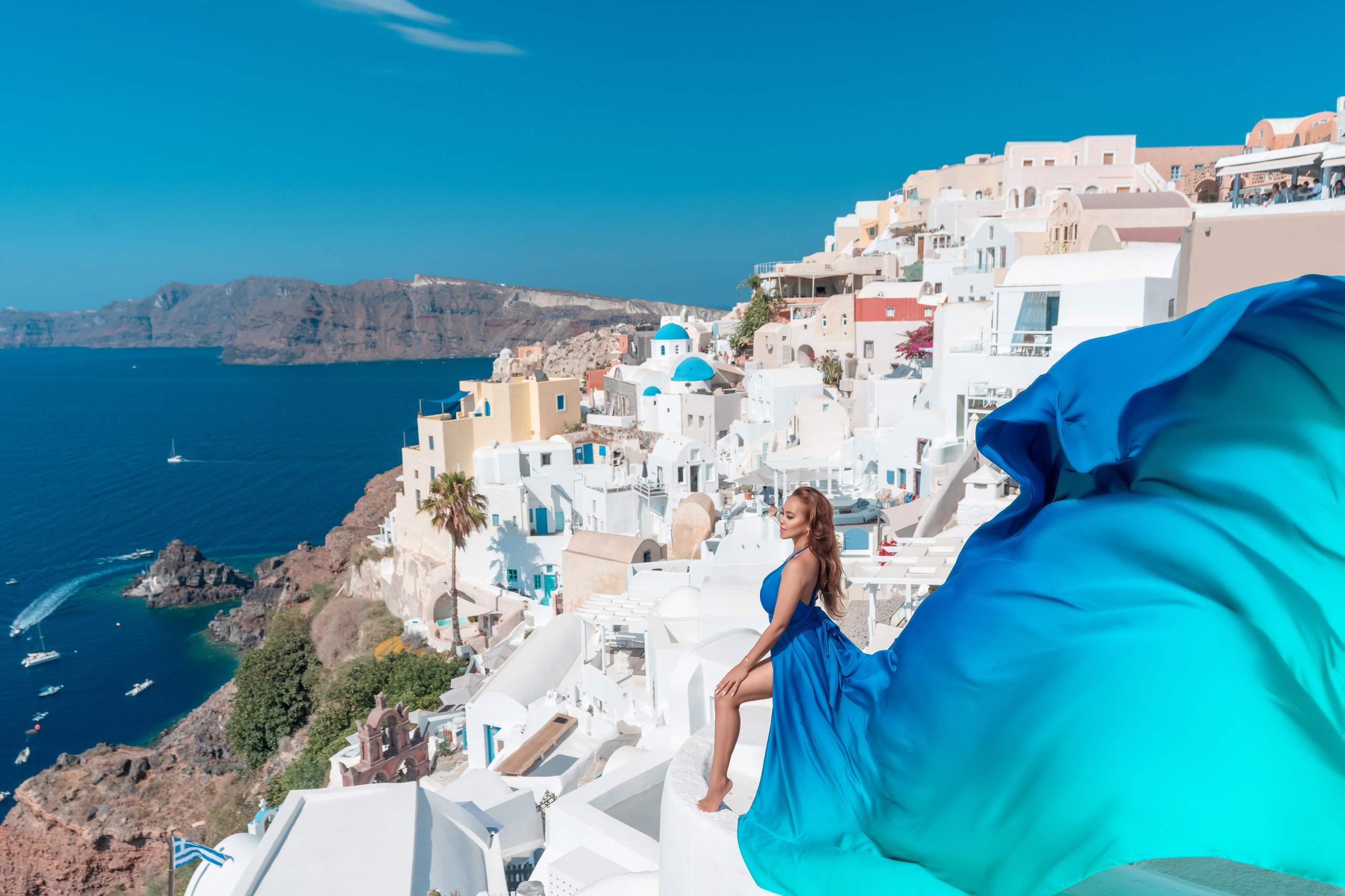 Séance Photo Couple avec Robe Volante Bleue Royale à Santorin – Expérience Élégante et Romantique. Photographe vidéaste à Santorin|Séances photos de Robe volante Santorin|