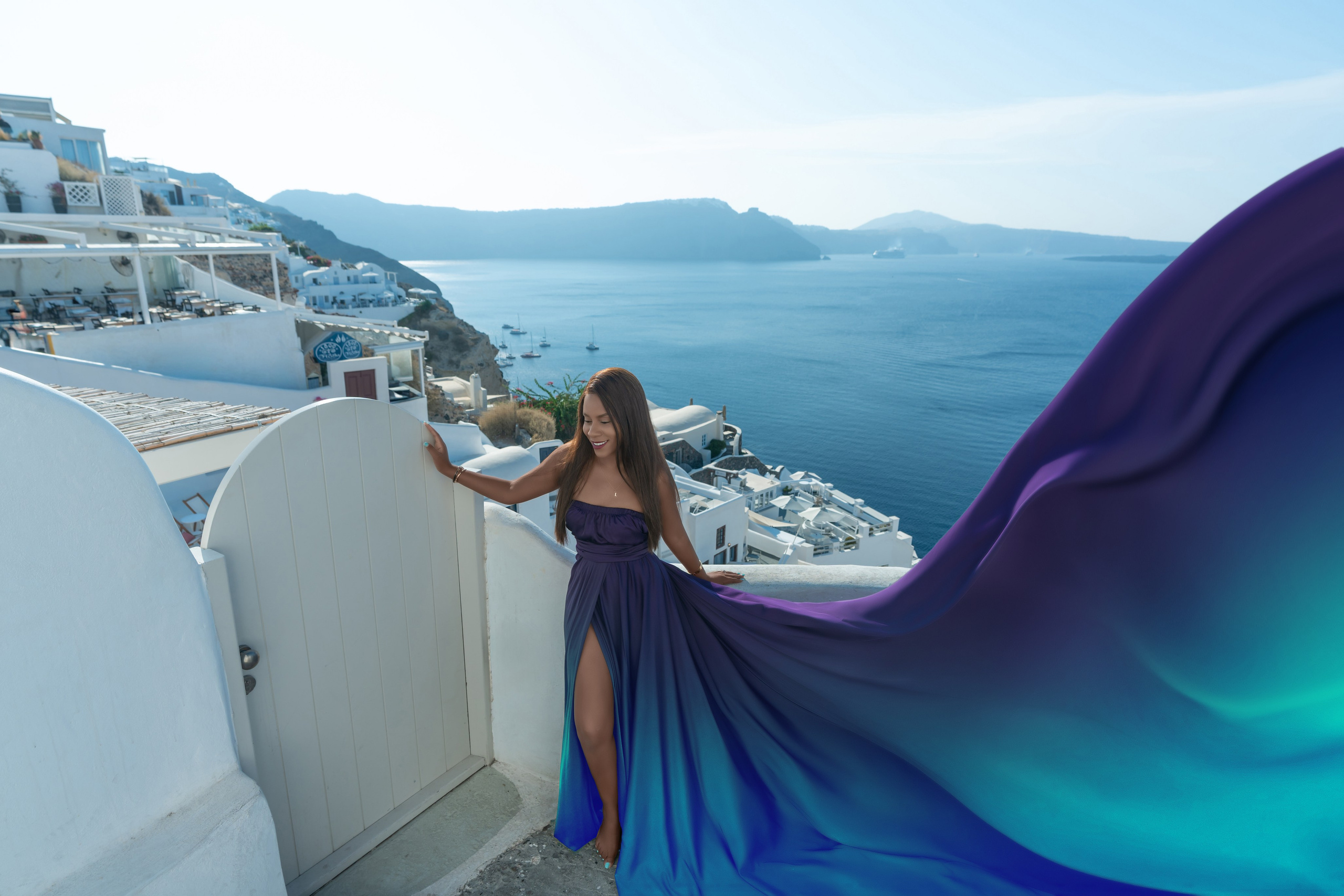 Grace and Glamour: A Couple’s Dream Photoshoot in Oia with a Violet Flying Dress