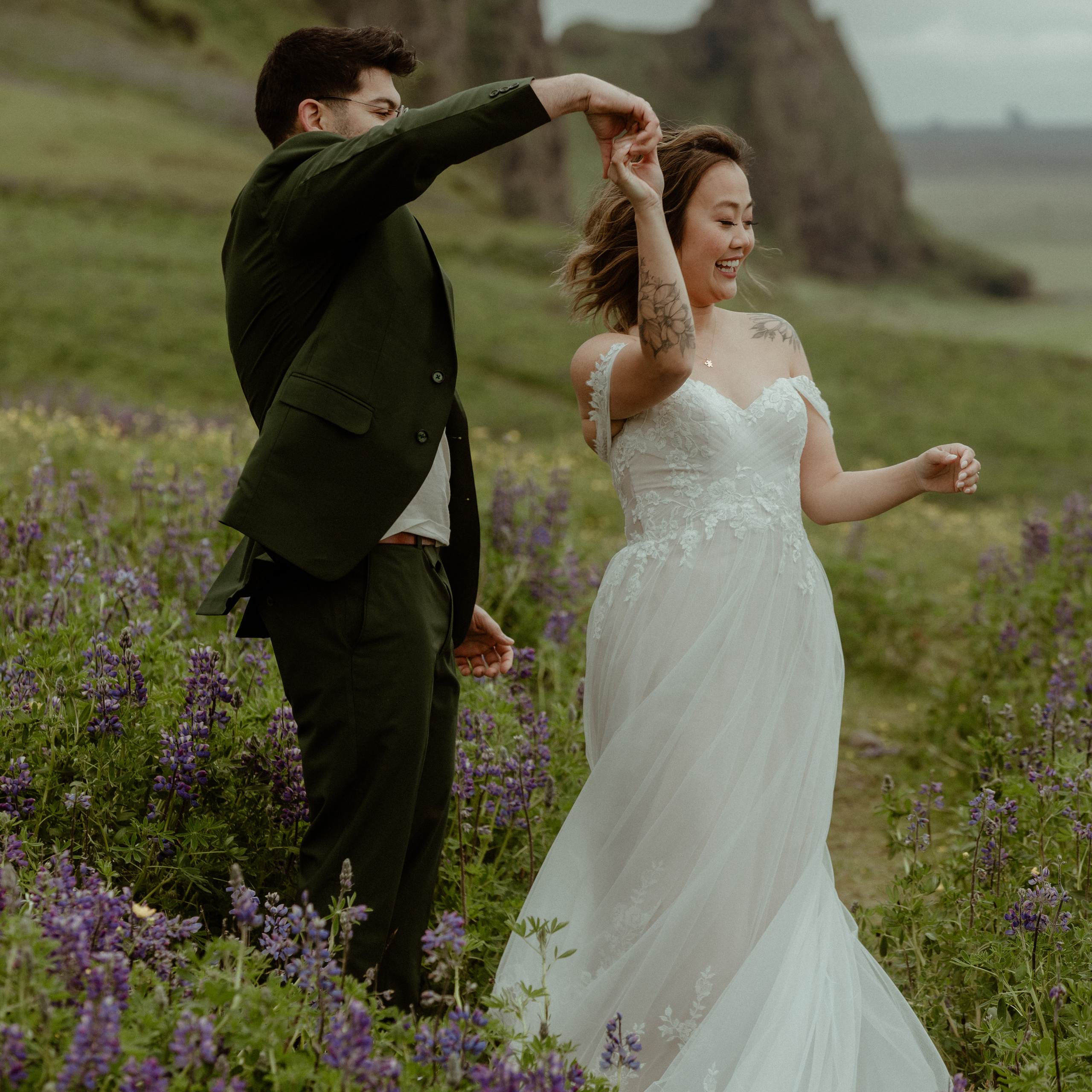 Couple dancing in lupines field in Iceland on their wedding day