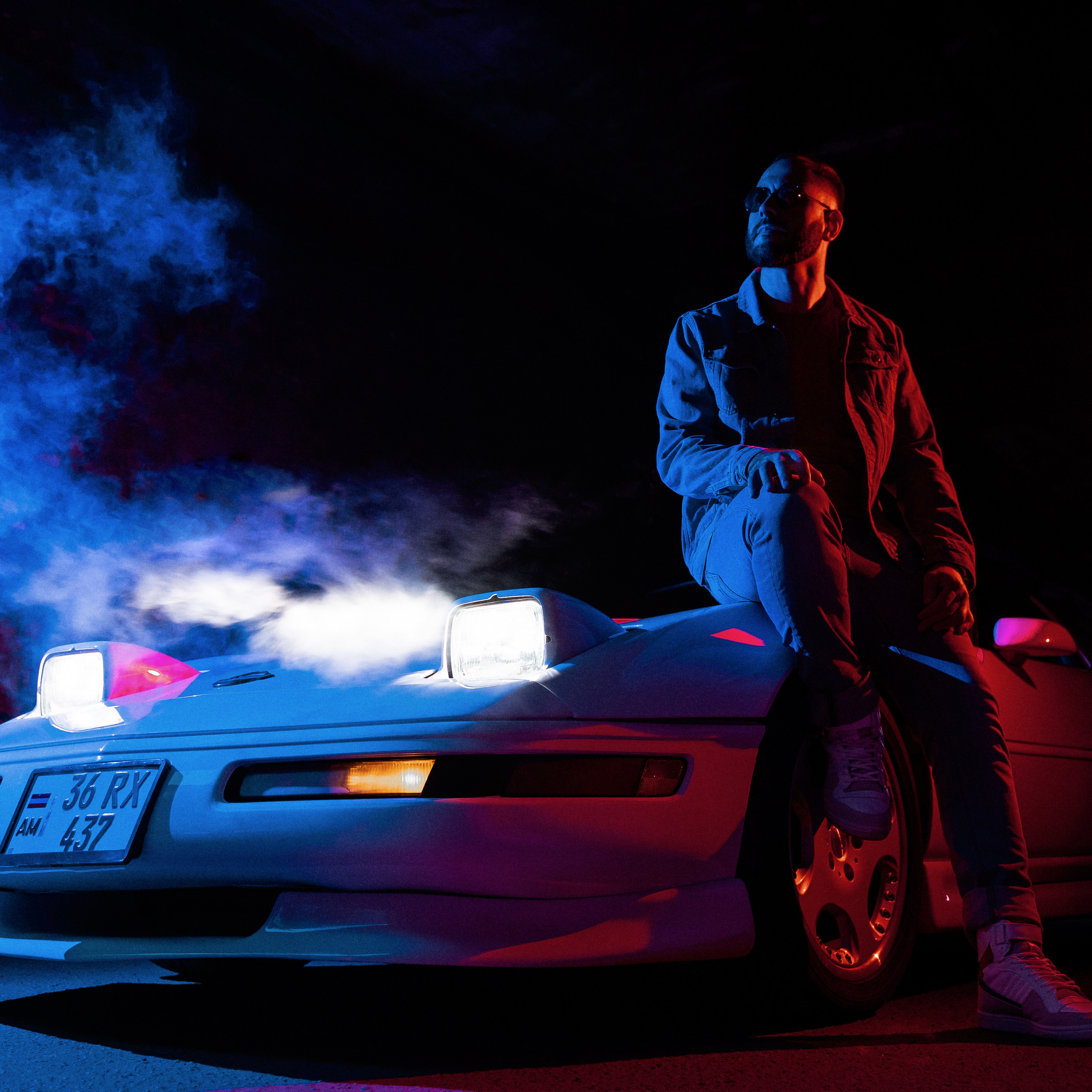 A trendy individual sitting on the hood of a sports car under neon lights, evoking a sense of cool urban nightlife.
