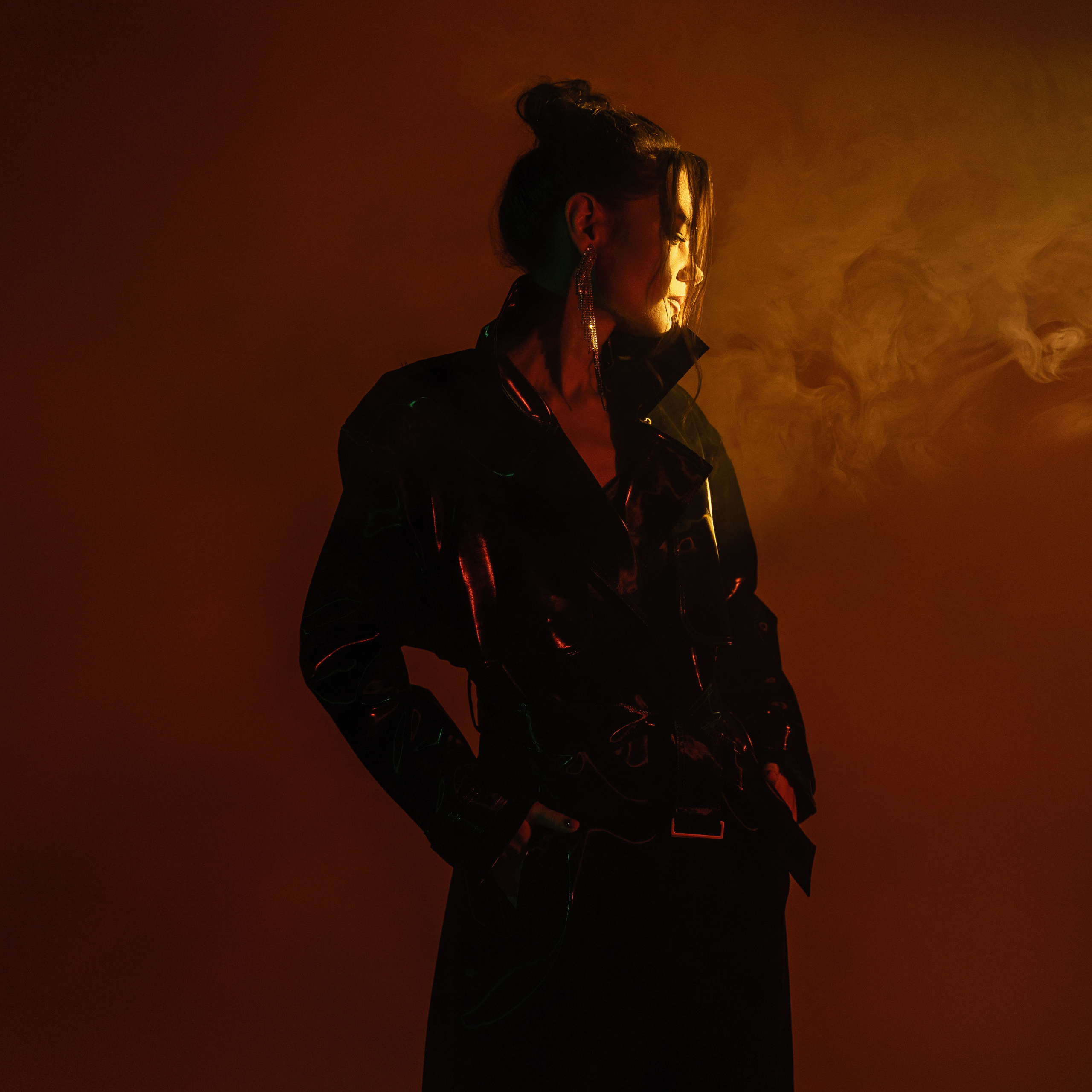 Artistic portrait of a woman in a dark room lit with red light