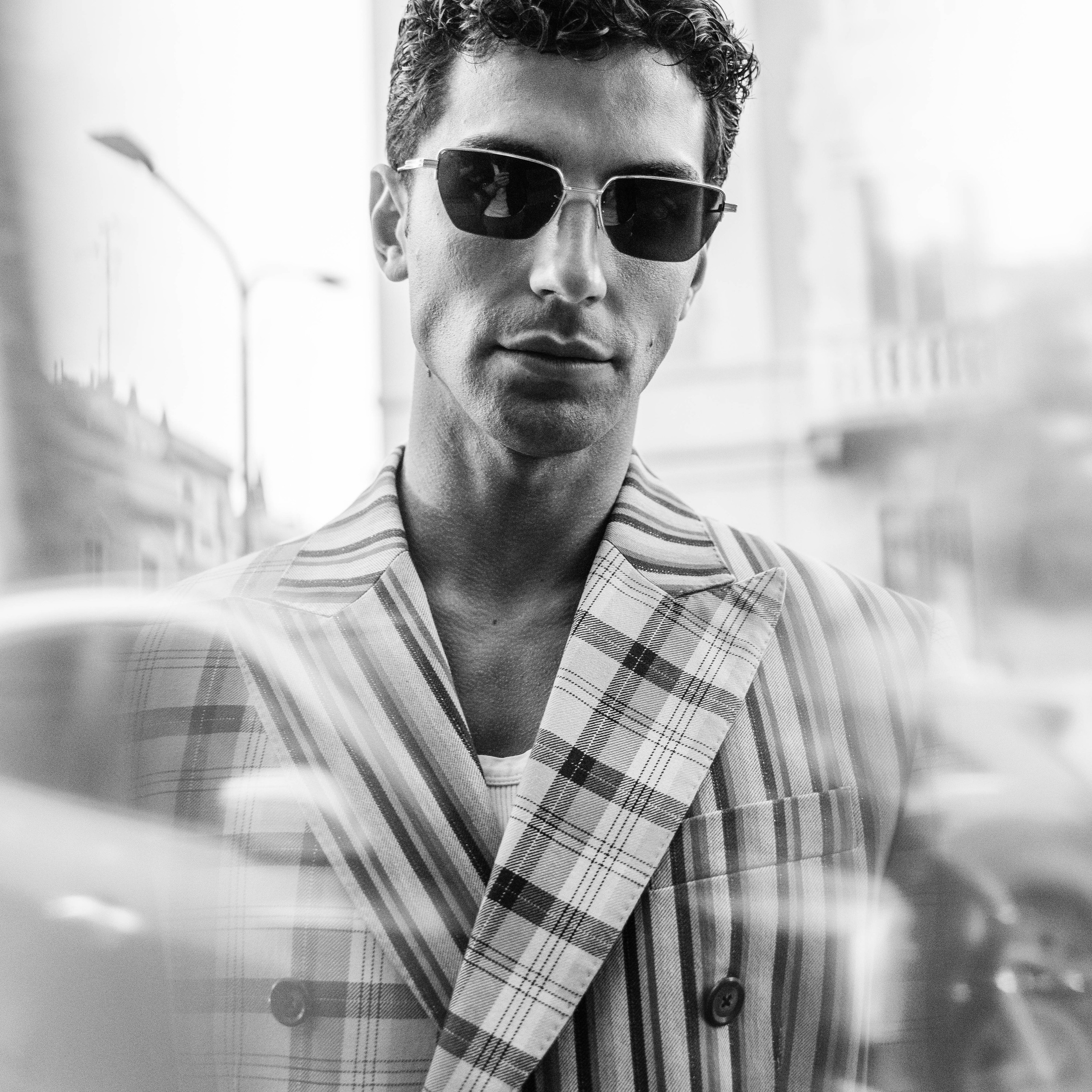 Monochrome portrait of a man in striped blazer and sunglasses