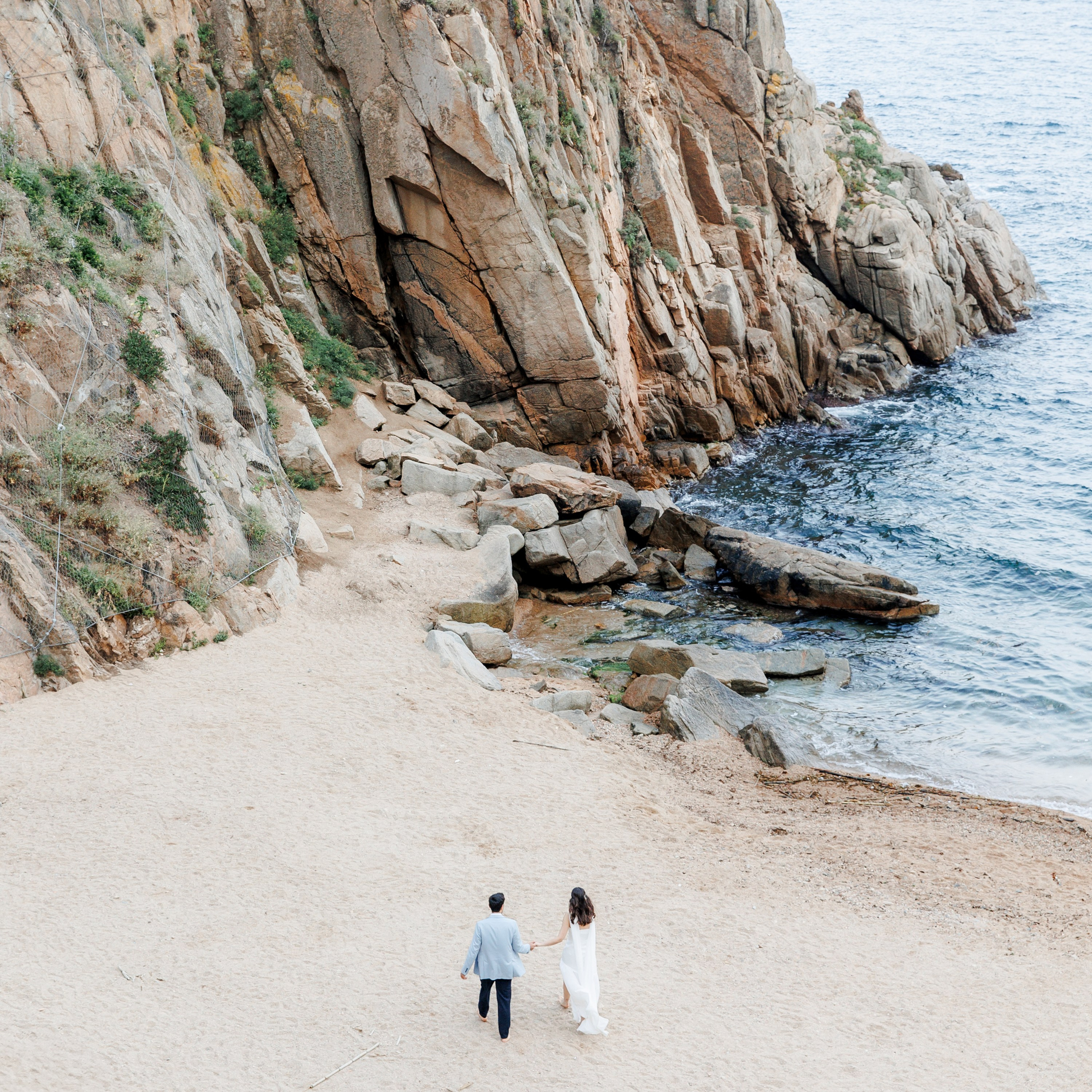 Destination wedding couple posing at a beach near Barcelona before their big day