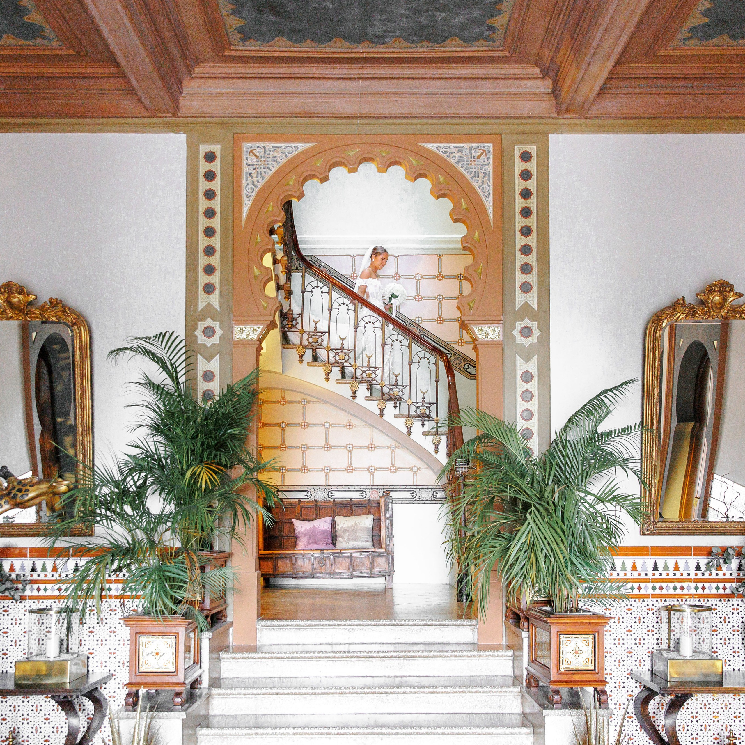 The bride is going down the staircase before entering the aisle in Gran Villa Rosa