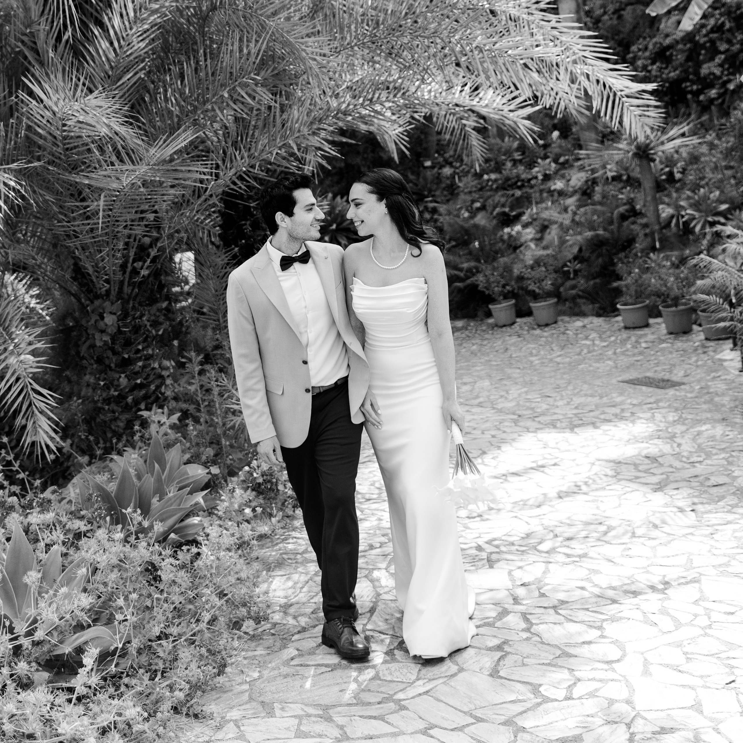 Engaged couple laughing together at botanical garden Marimurtra