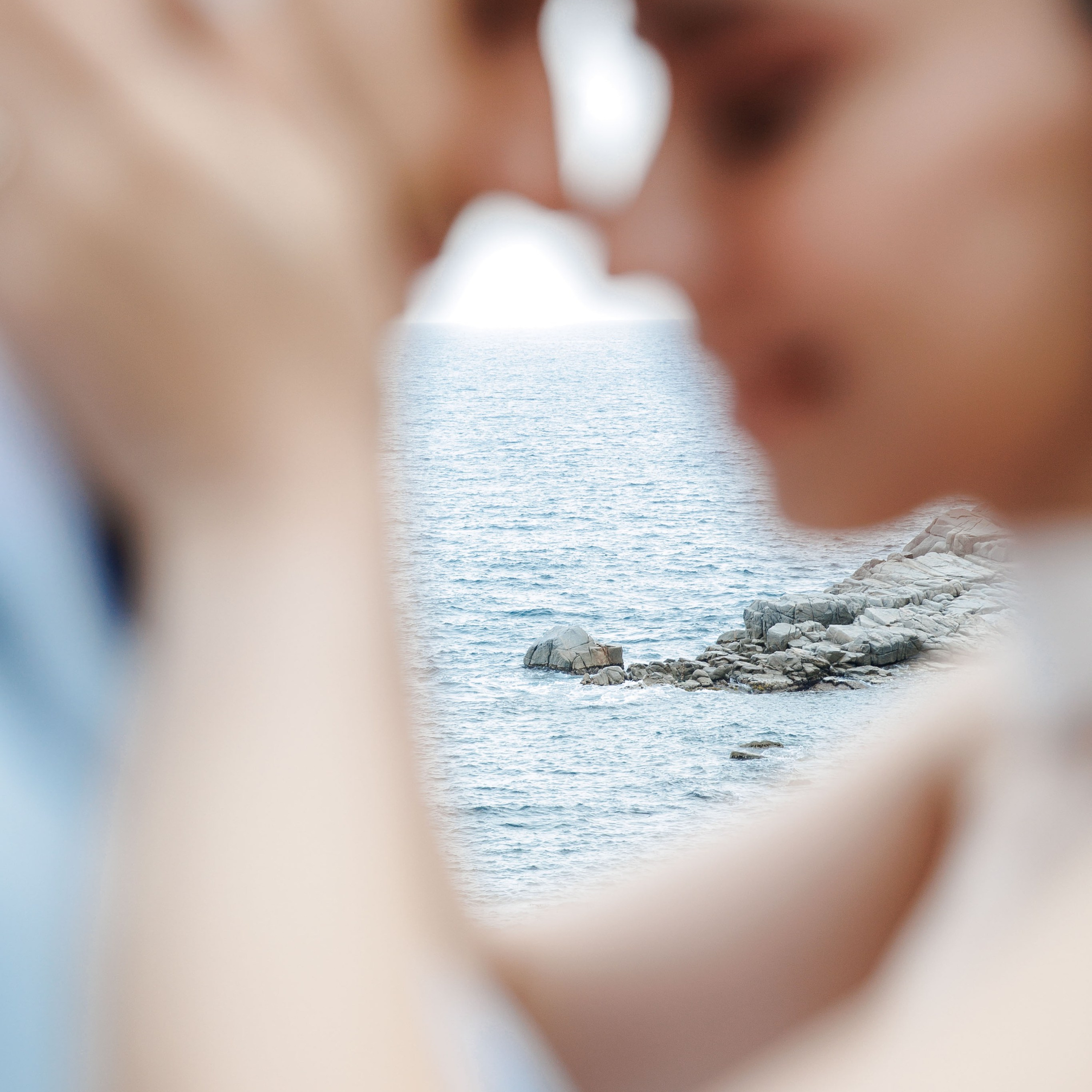 Close-up shot of a couple in love with Mediterranean sea in the background