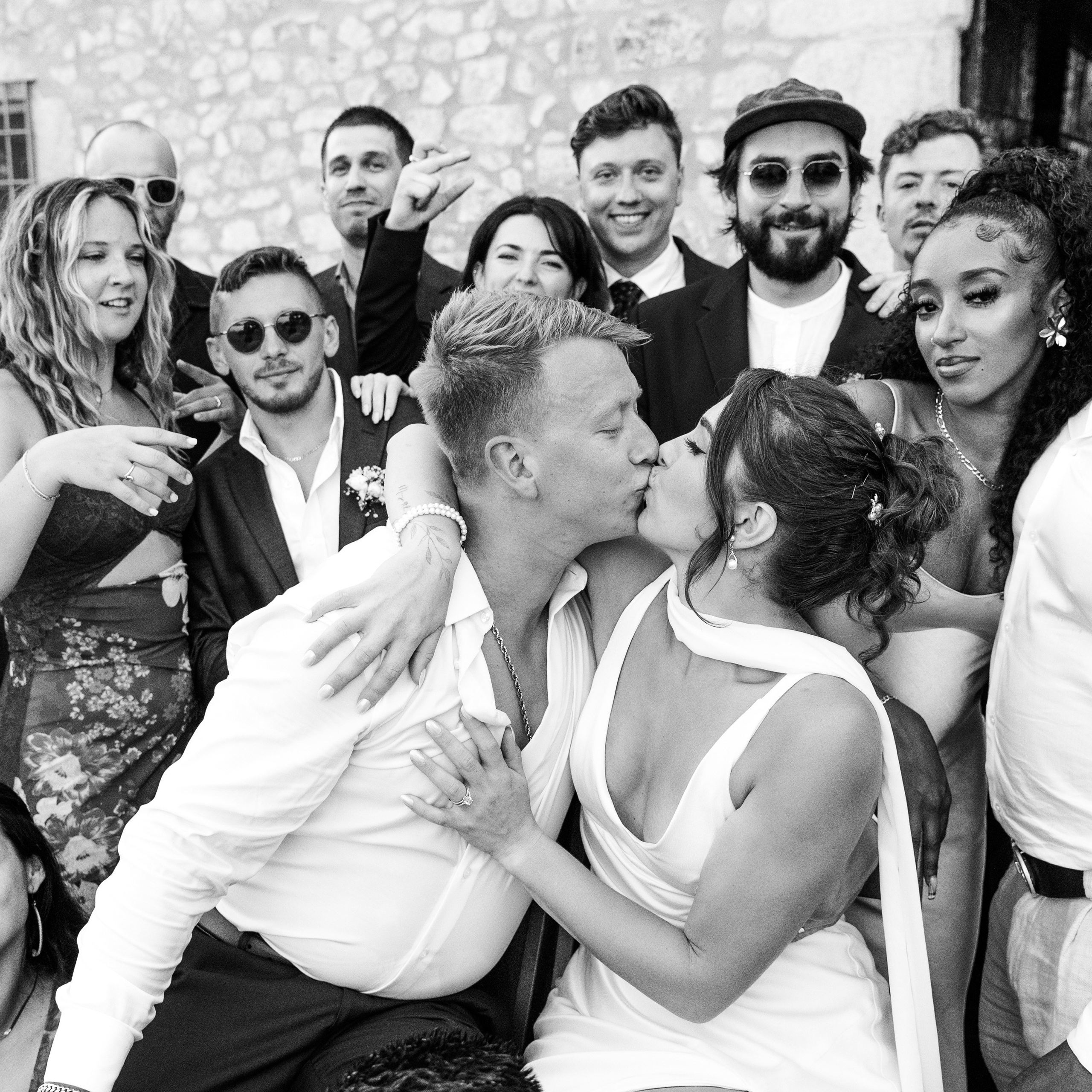 Bride and groom surrounded by friends celebrationg thier wedding during the destination wedding in Barcelona