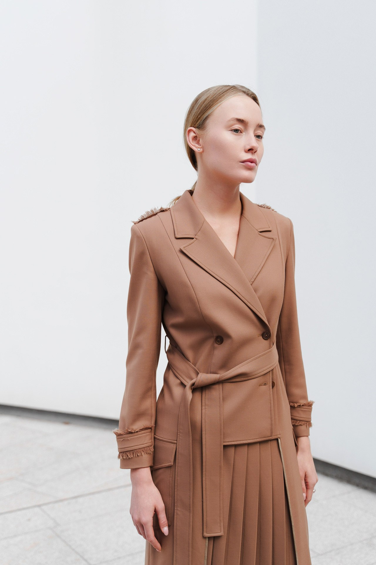 Female model in a structured beige dress during a portfolio session in Milan