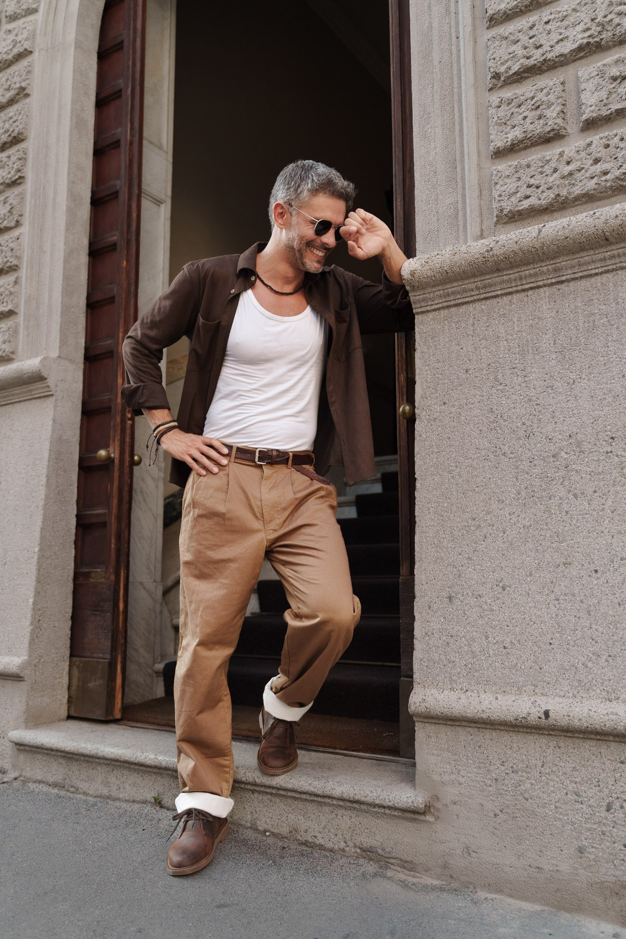 Lifestyle model test of a mature male model smiling in casual outfit on a Milan street