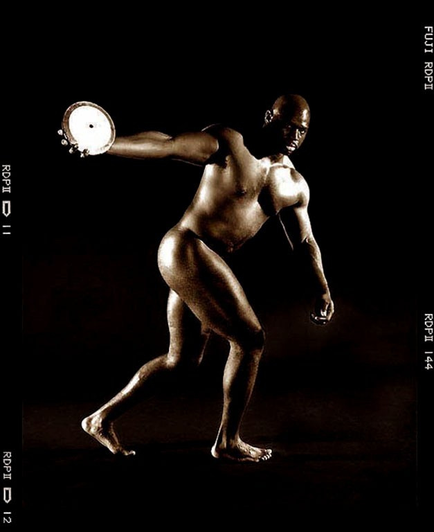 Olympic discus athlete in monochrome studio portrait.