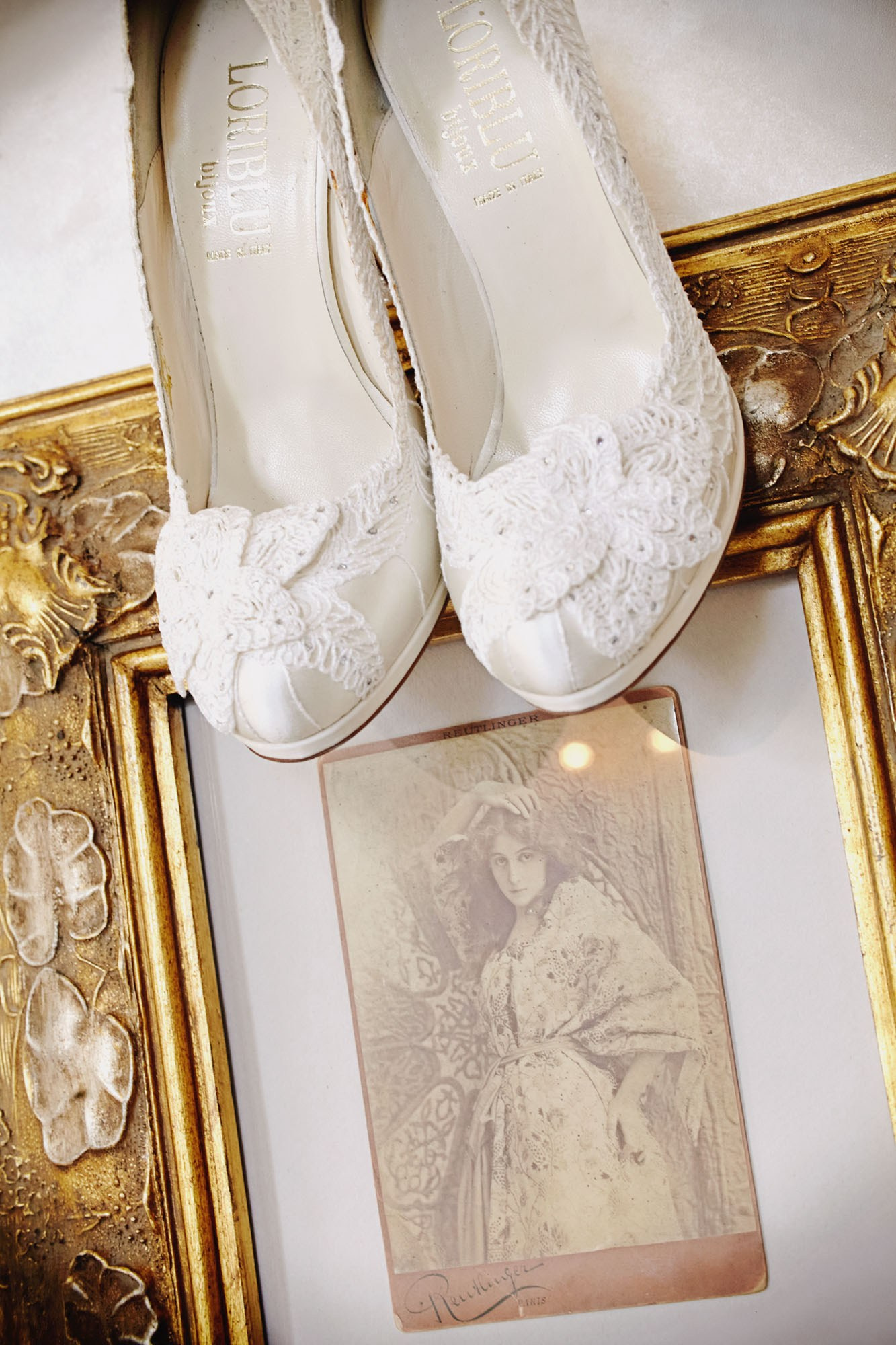 Bridal shoes displayed on a vintage portrait in the Chateau Mcely bridal suite.