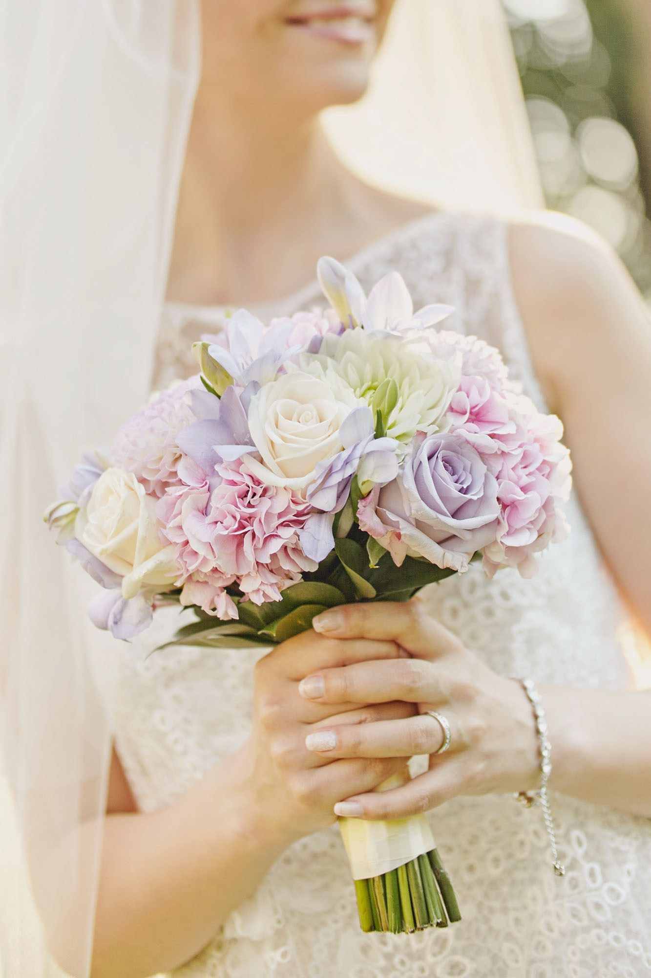 The bride, glowing with happiness, poses with her bouquet on the historic grounds of Chateau Mcely, Czechia, post her enchanting garden wedding.