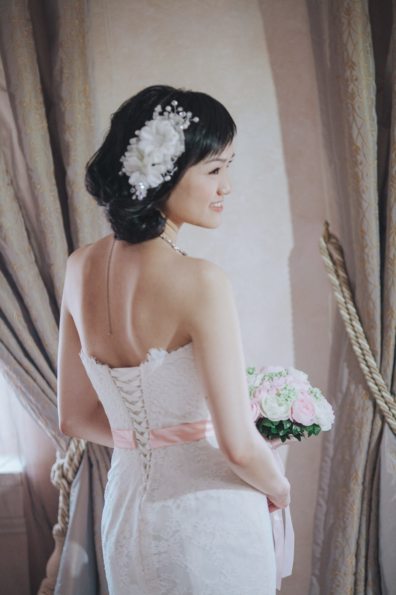 A Hong Kong bride poses with her bouquet in her luxury suite in Prague following her wedding preparation.