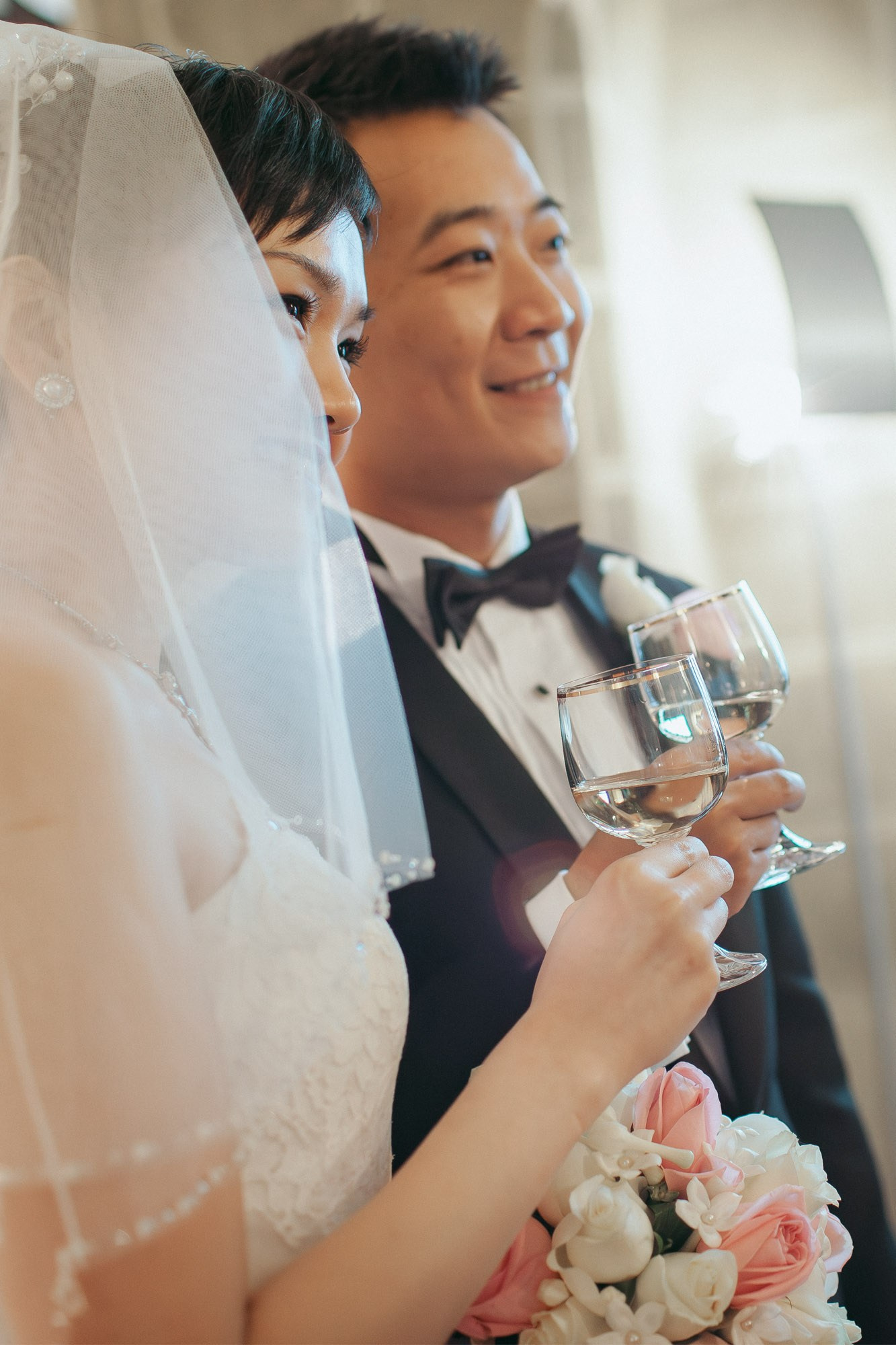 The radiant bride and smiling groom enjoy champagne after marrying at the State Chateau of Hluboka during their destination wedding in Czechia.