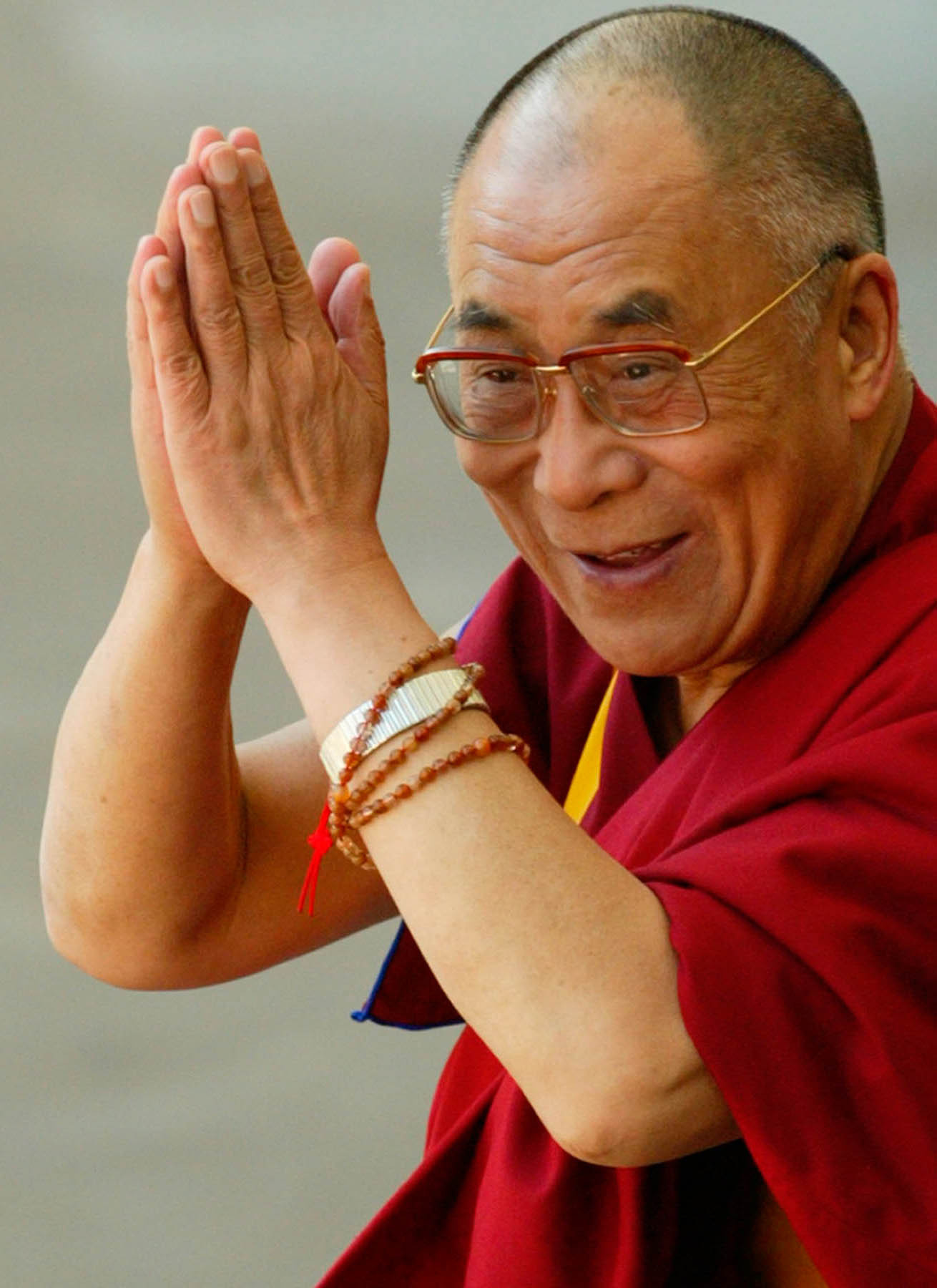 Dalai Lama smiling in candid portrait.