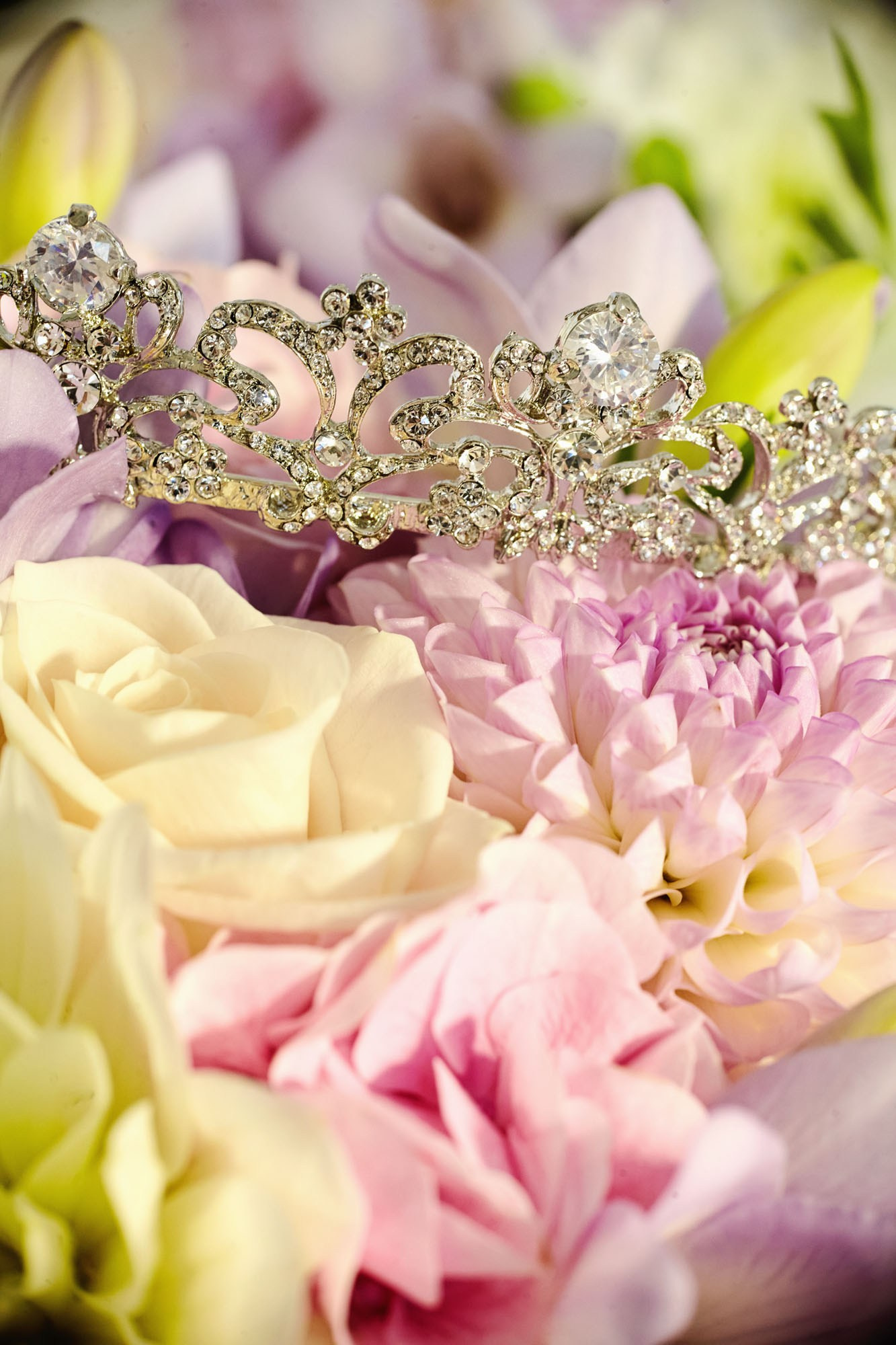Bridal tiara resting on top of a colorful bouquet of flowers.