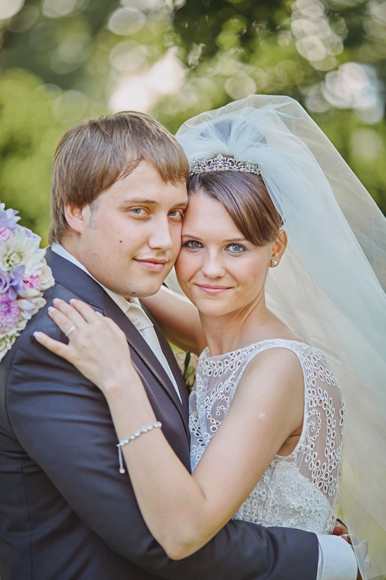 Wedding bliss at Chateau Mcely: Bride and groom share an intimate hug in the stunning garden backdrop.