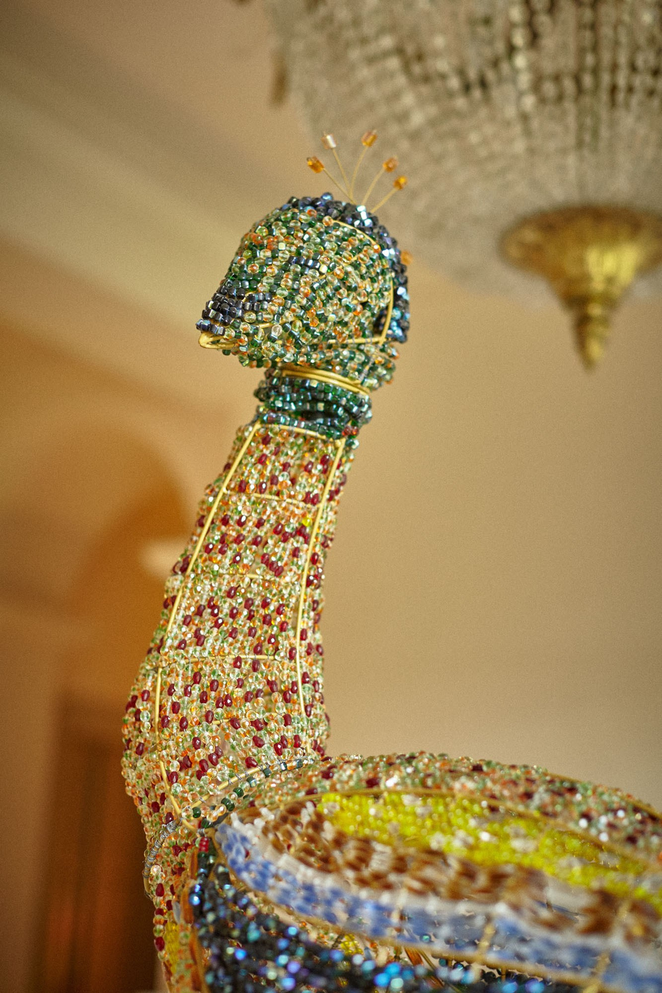 A peacock made out of glass beads adorns the interior of the Chateau Mcely.