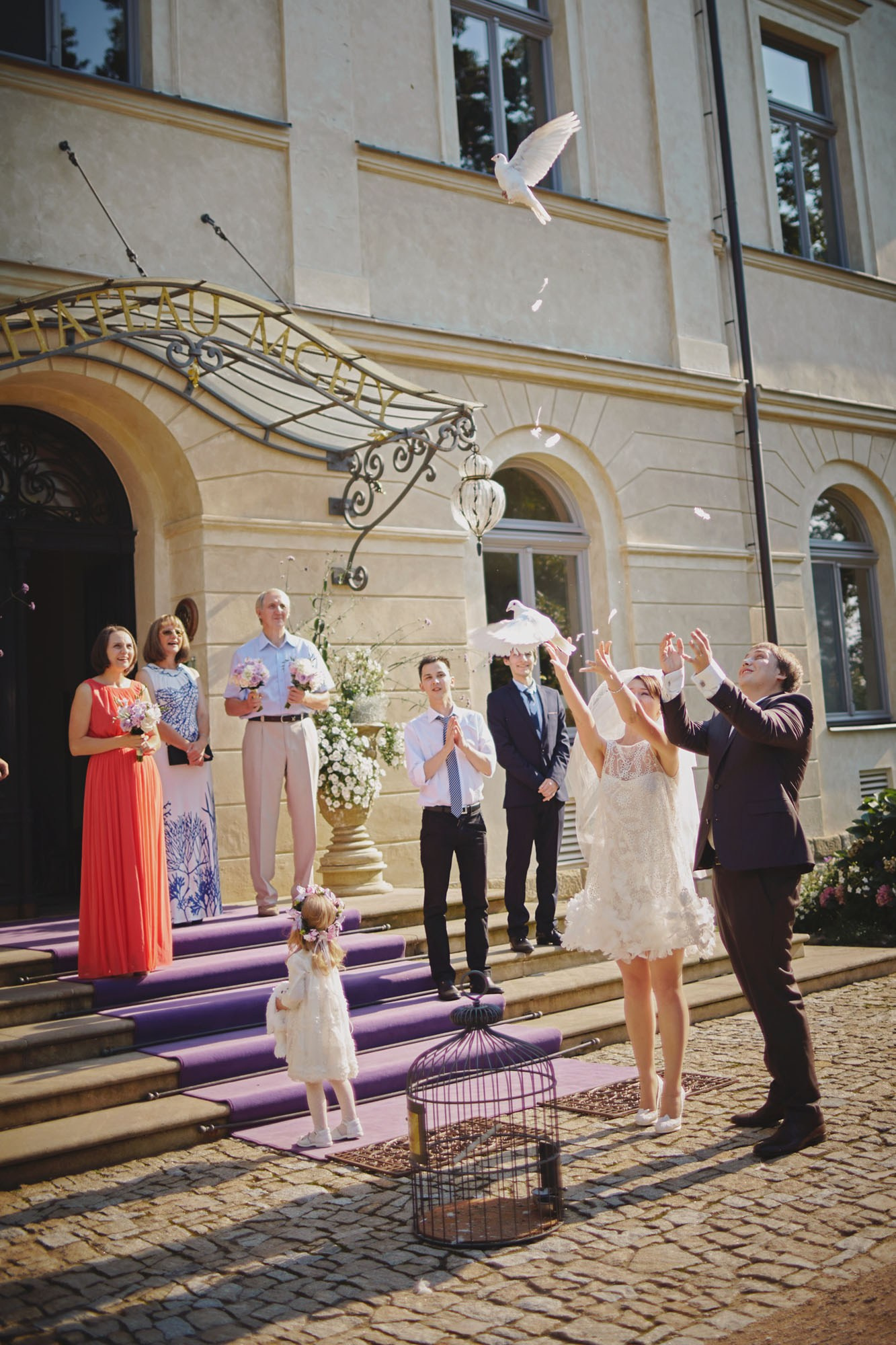Russian newlyweds releasing doves at Chateau Mcely wedding.