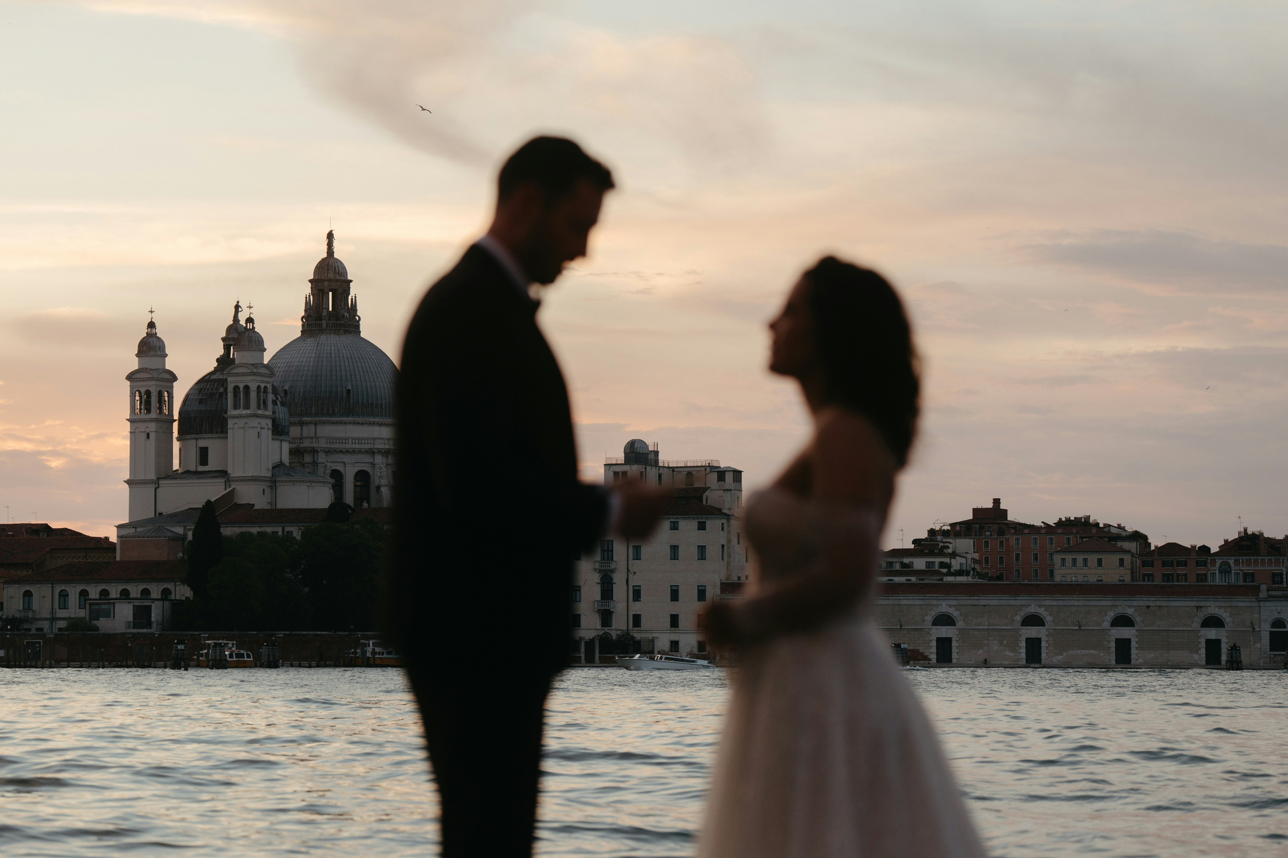 Bride and groom enjoying a gondola ride through Venice's serene canals.