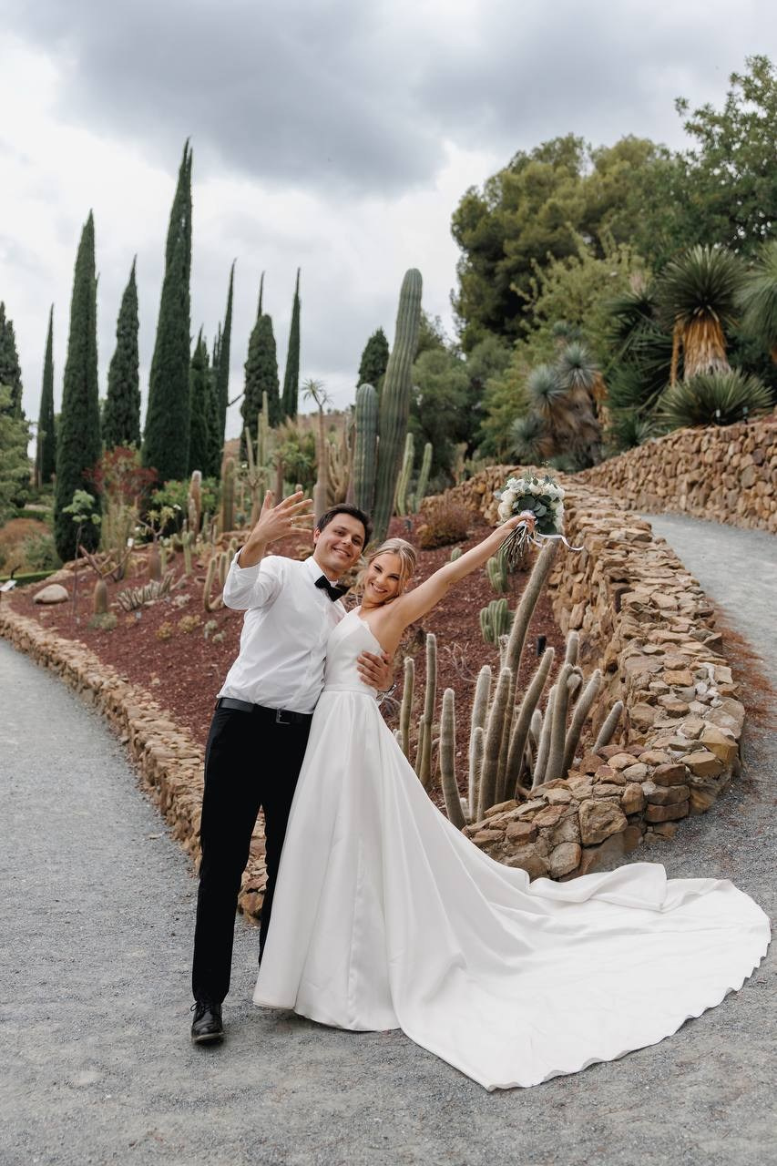 Groom and bride kissing on the street in old Spanish town