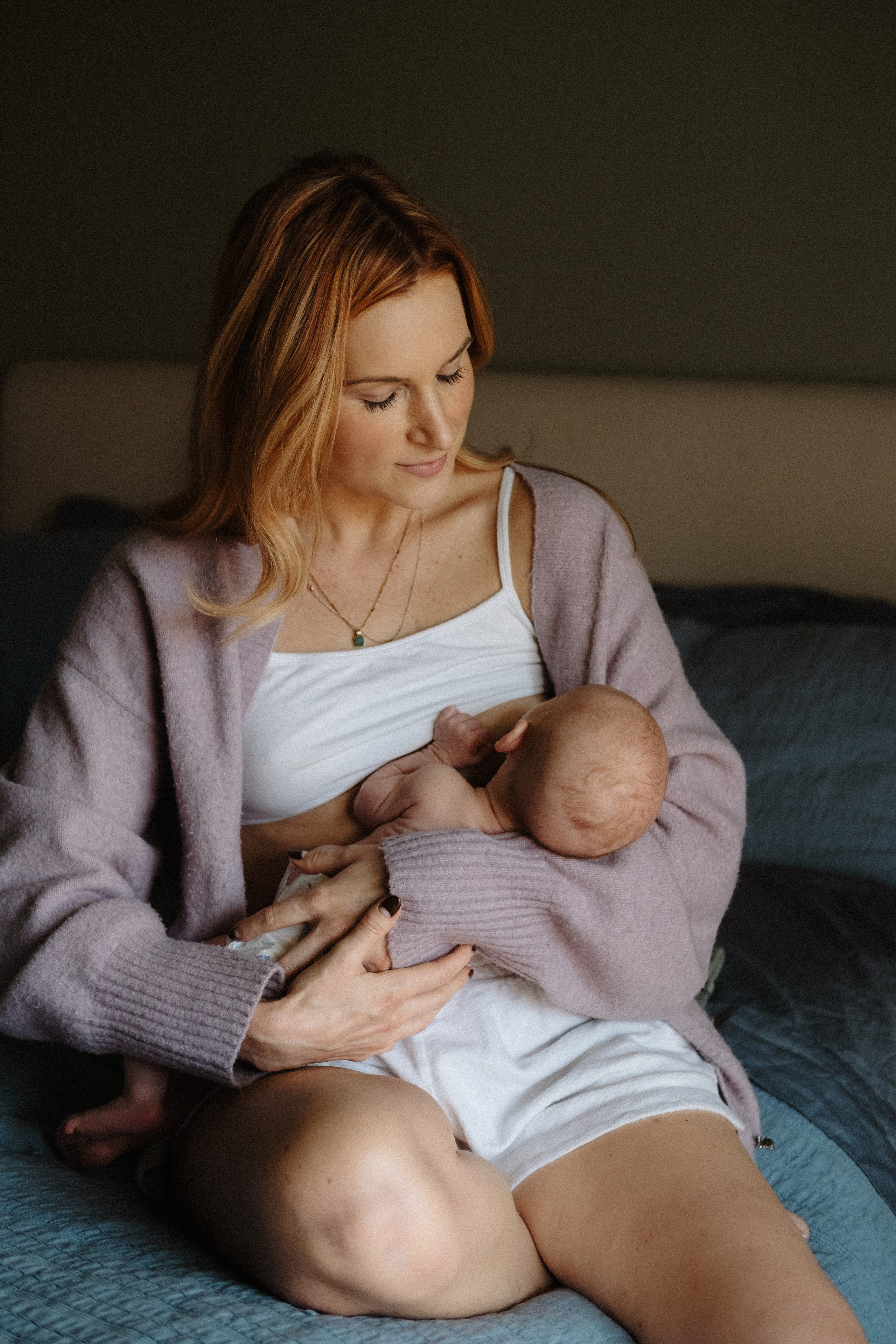 A mother holding her newborn baby in her arms, intimate portrait of motherhood in Richmond, VA