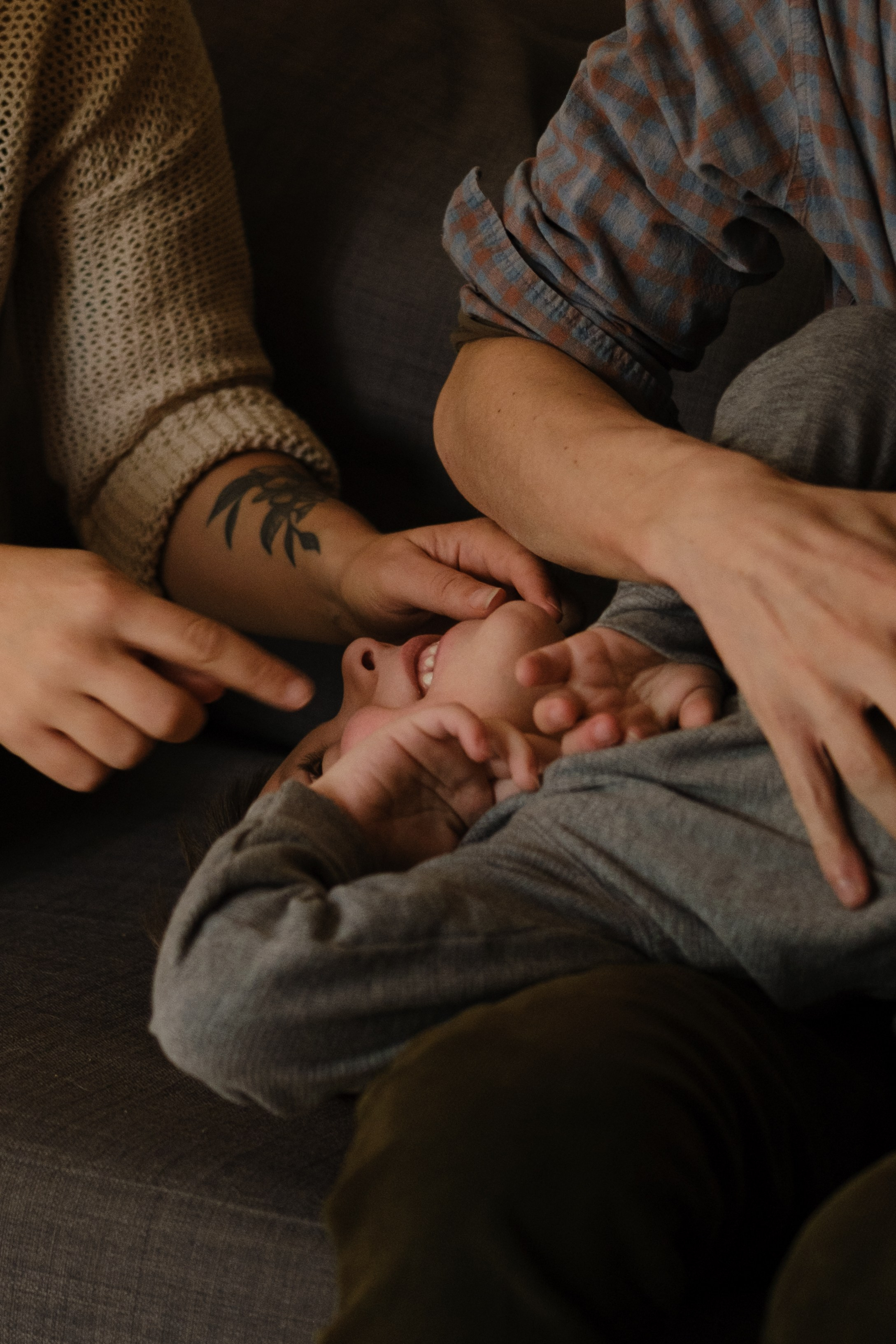 Parents embracing their neurodivergent twin boys during a candid family photoshoot