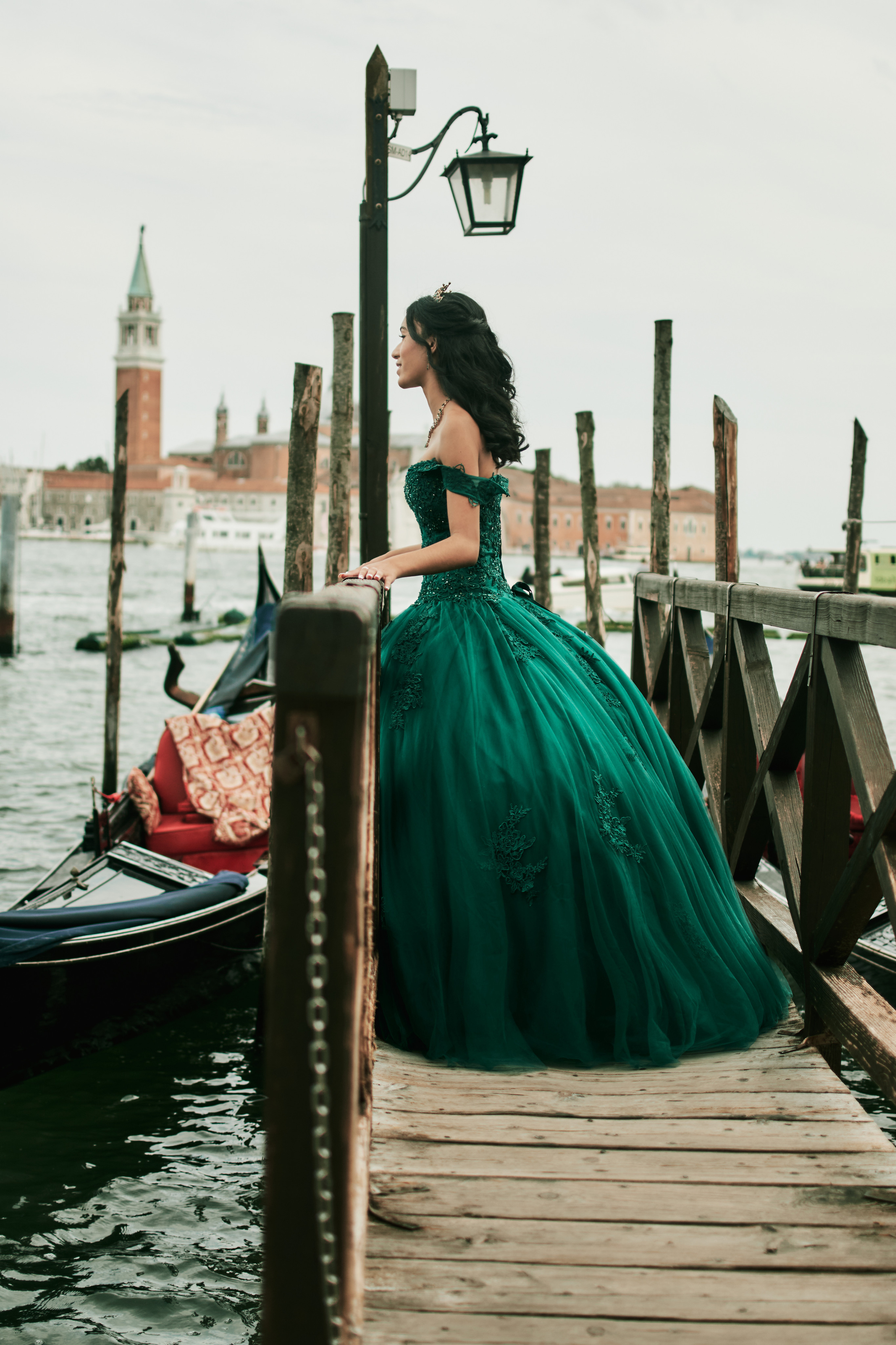 Step into a fairy tale world with a magical quinceanera photoshoot set against the breathtaking backdrop of Venice. Quinceañera radiating elegance in a stunning Venice photoshoot at St. Mark's Square.Radiant girl in a captivating green dress exuding elegance.