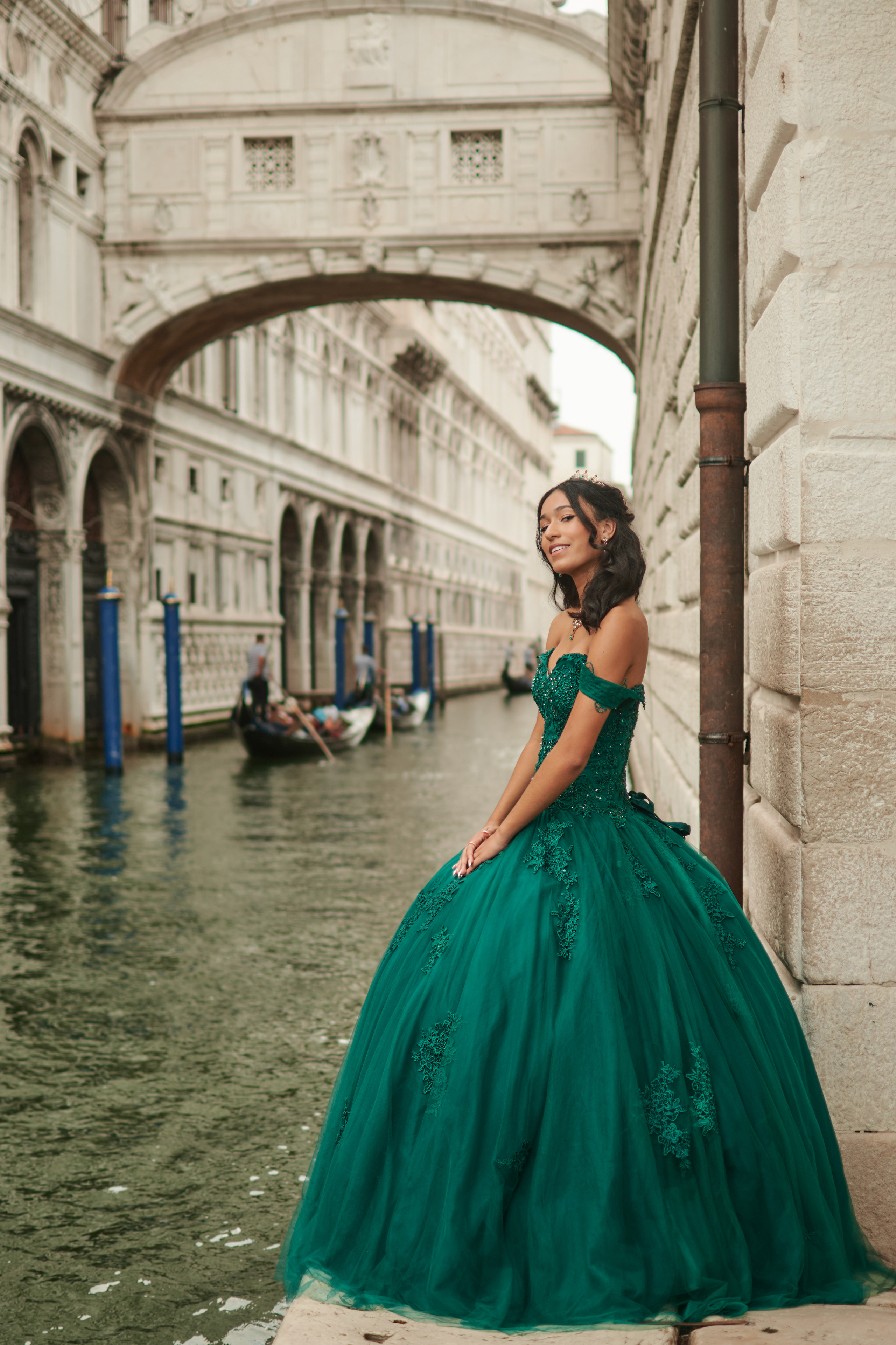 Venetian charm meets quinceanera grace at St. Mark's Square – a captivating photoshoot. Mesmerizing green dress complements the girl's natural beauty.