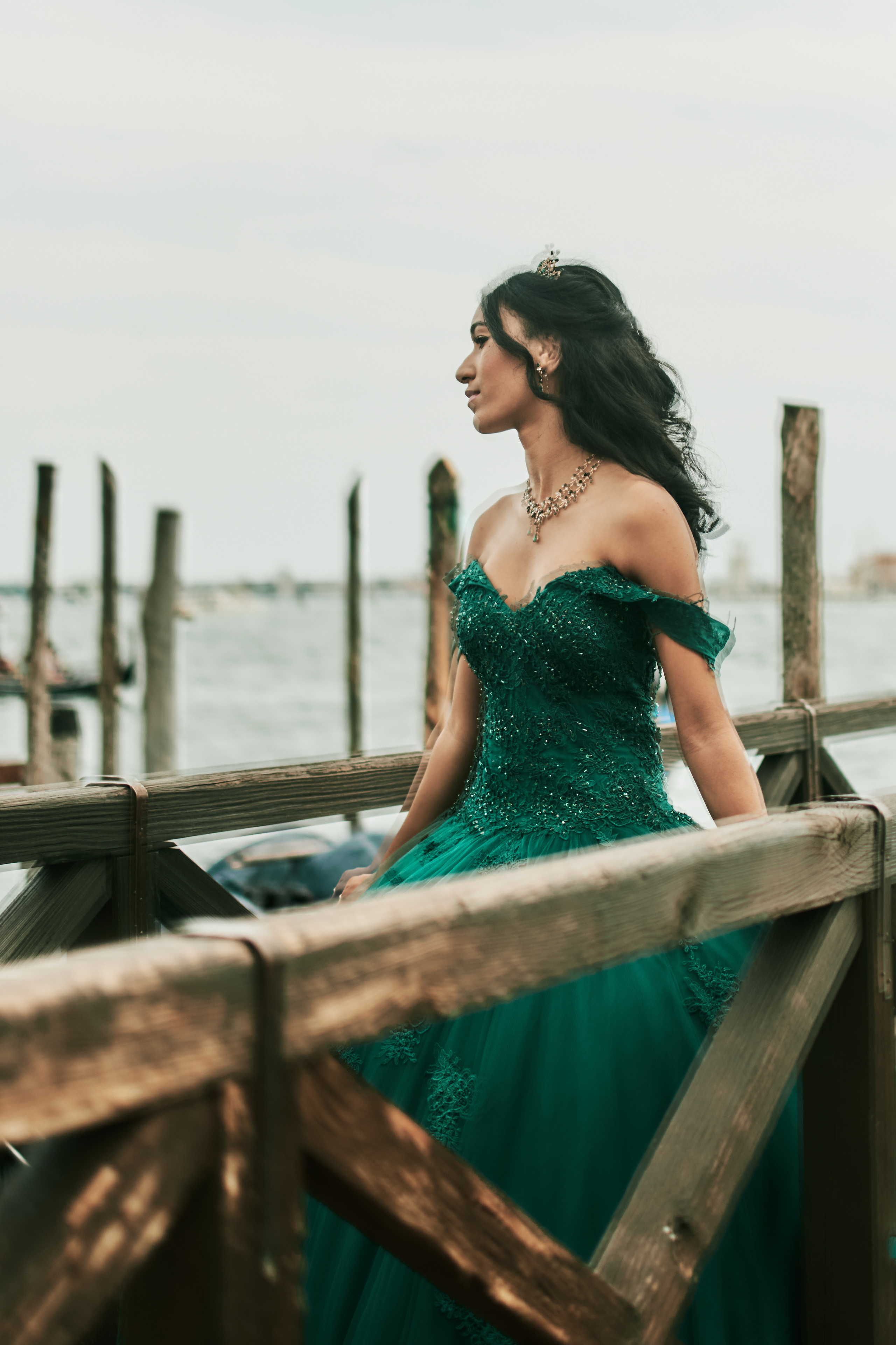 Captivating quinceanera photoshoot amidst the grandeur of St. Mark's Square, Venice. Enchanting beauty of a young woman in a stunning green dress.
