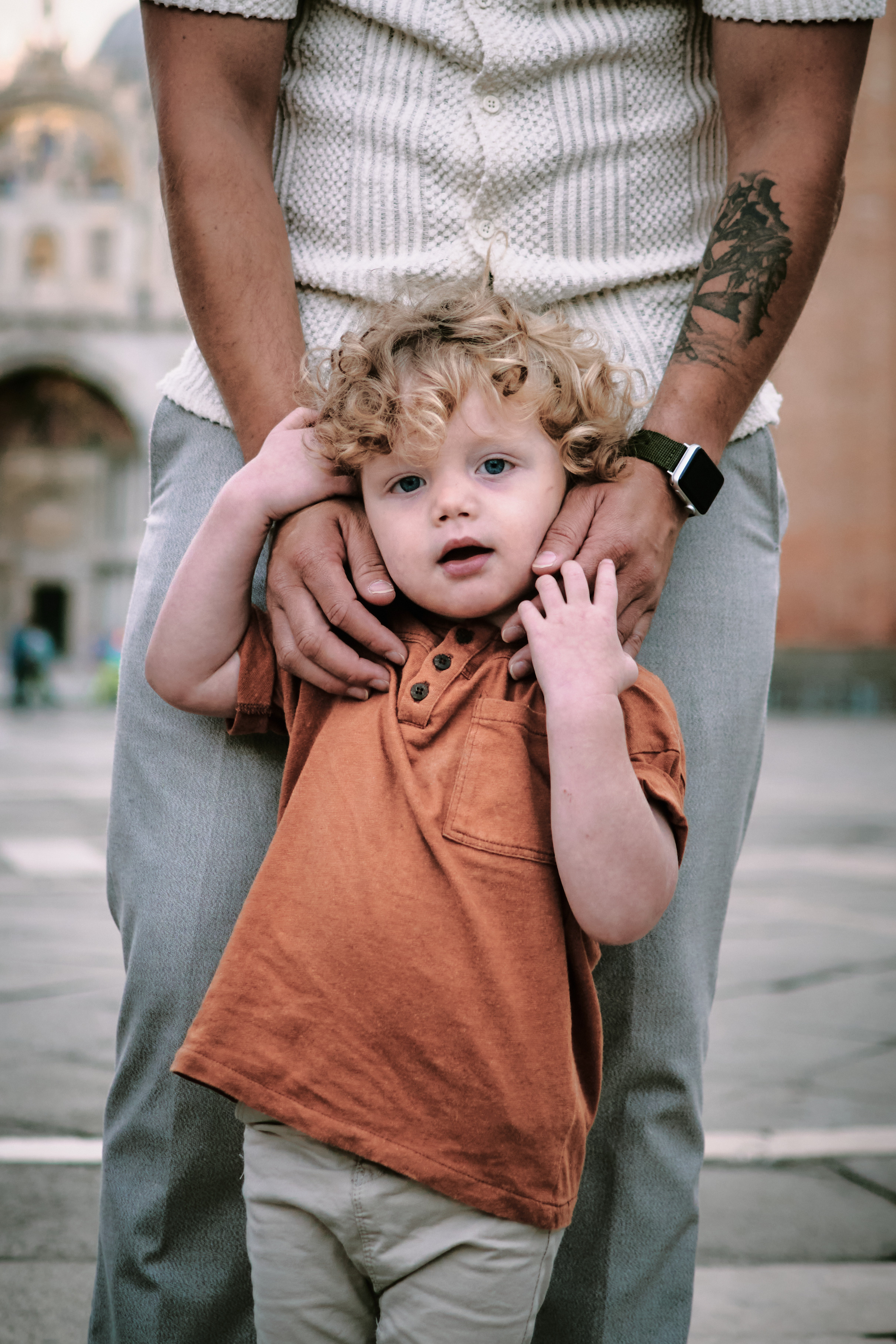 In the heart of Venice, a father and child capture a memory with a portrait on San Marco Square, surrounded by the city's iconic architecture.