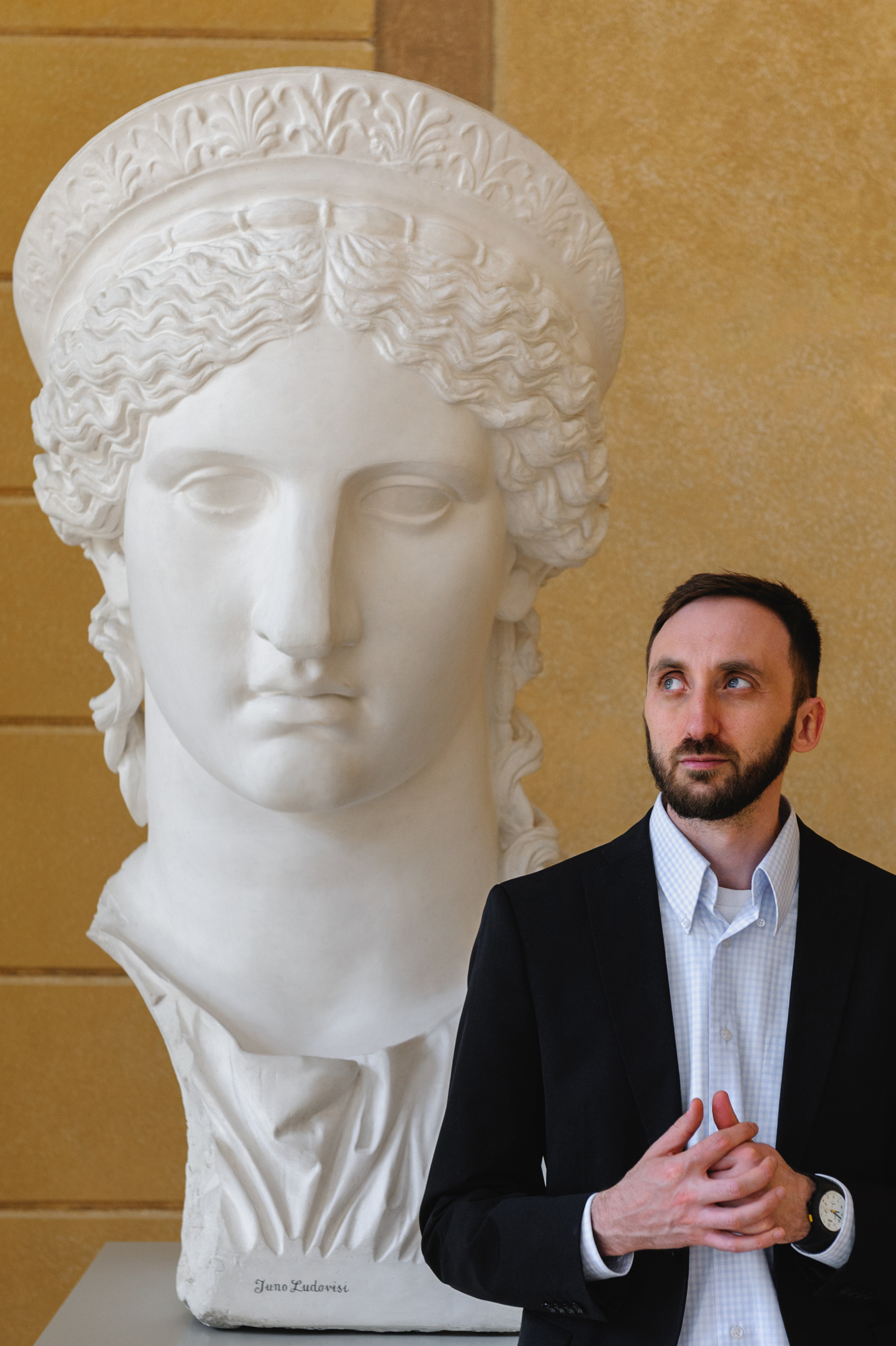 Art historian Dmitry Solodkiy with a sculpture of a giant Greek head. The Royal Baths Museum in Warsaw.