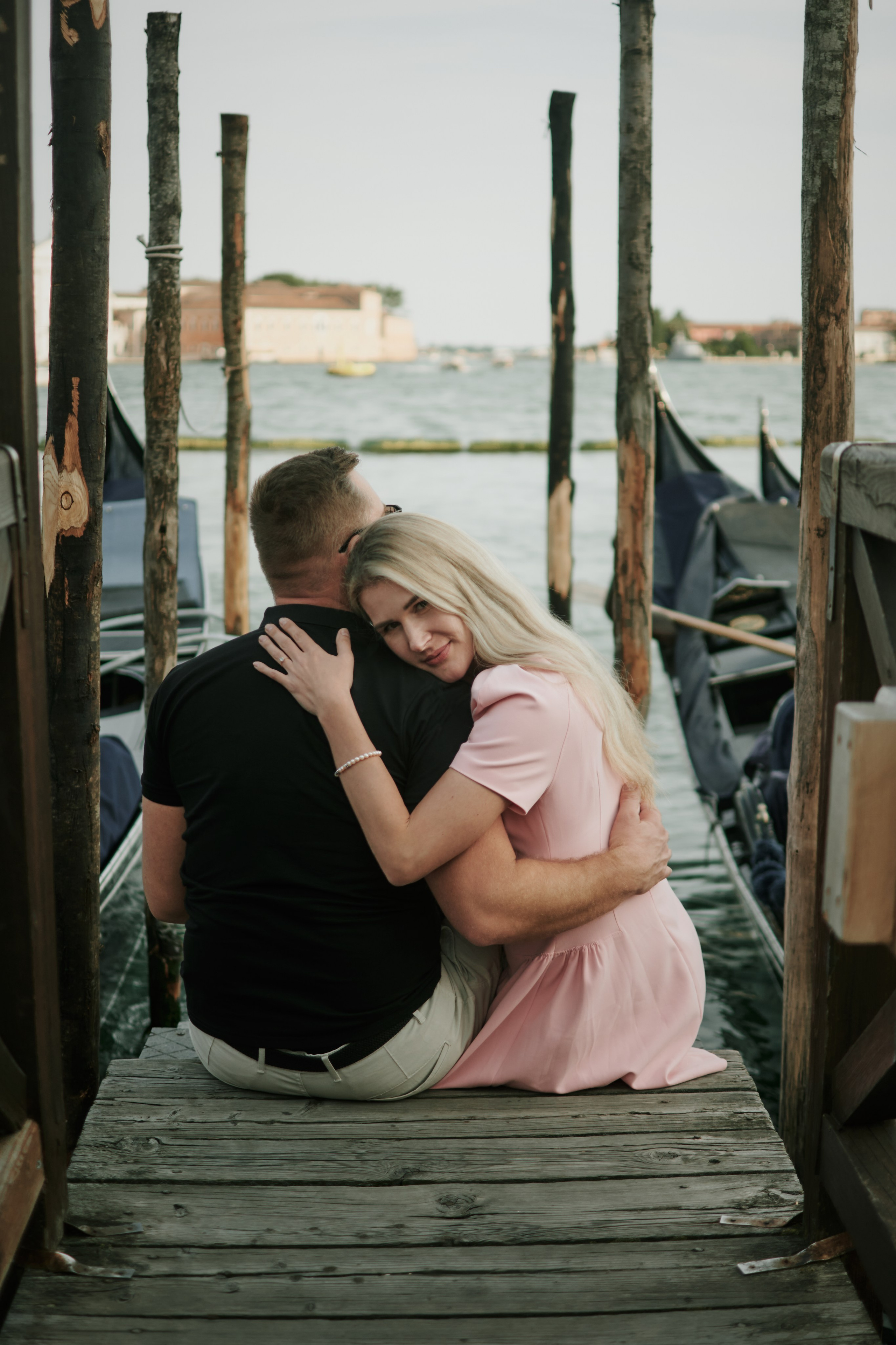 A stunning love story shoot takes place on San Marco Square, with the Bridge of Sighs providing an iconic backdrop. The photographer has expertly captured the essence of Venice's beauty, from the intricate stonework of the bridge to the stunning architecture of the surrounding buildings