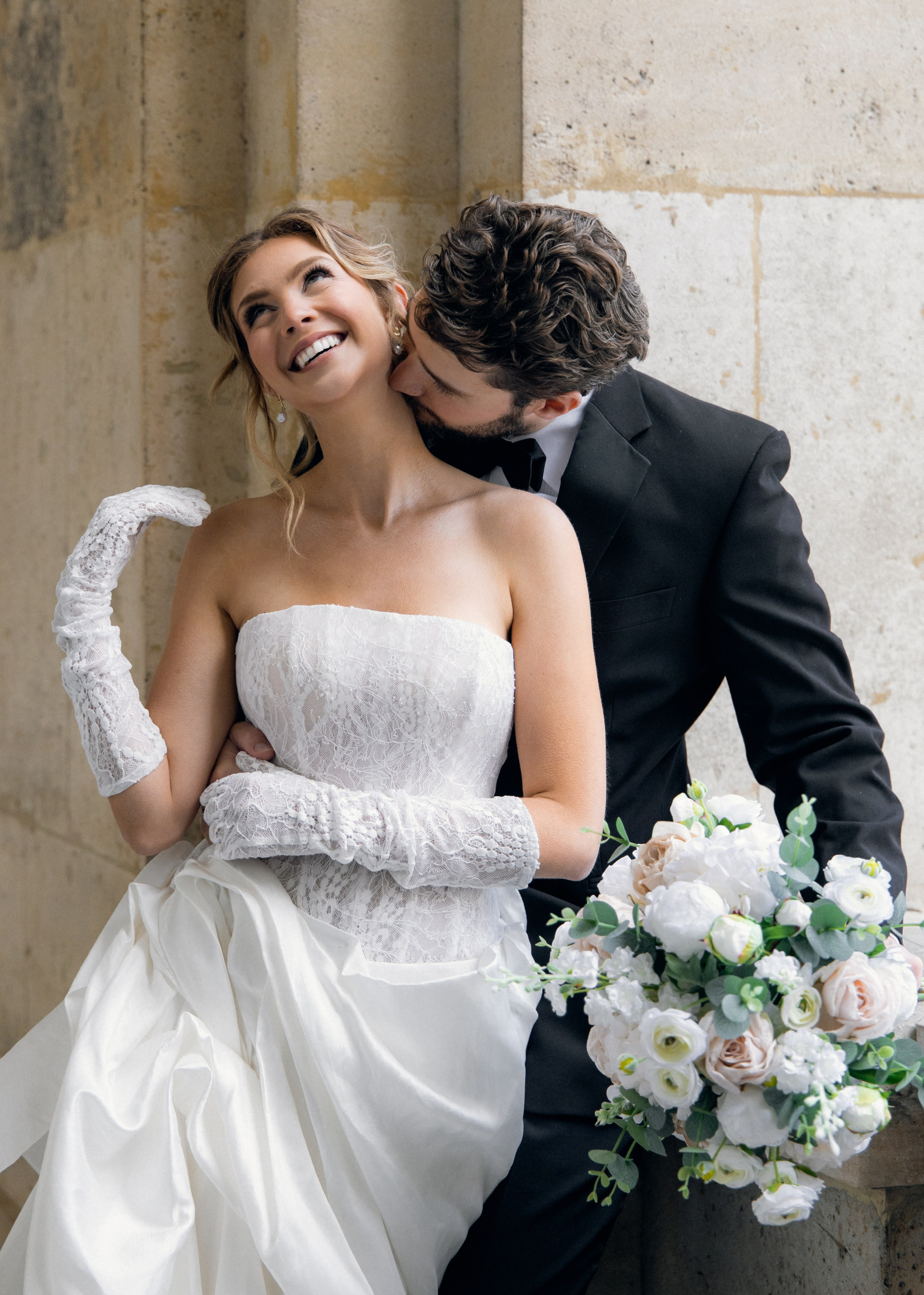 Bride and groom walking through romantic Paris street with soft morning light and elegant editorial styleTimeless Paris elopement photo with bride holding bouquet in golden hourCouple kissing in front of Eiffel Tower – luxury wedding photography in Paris