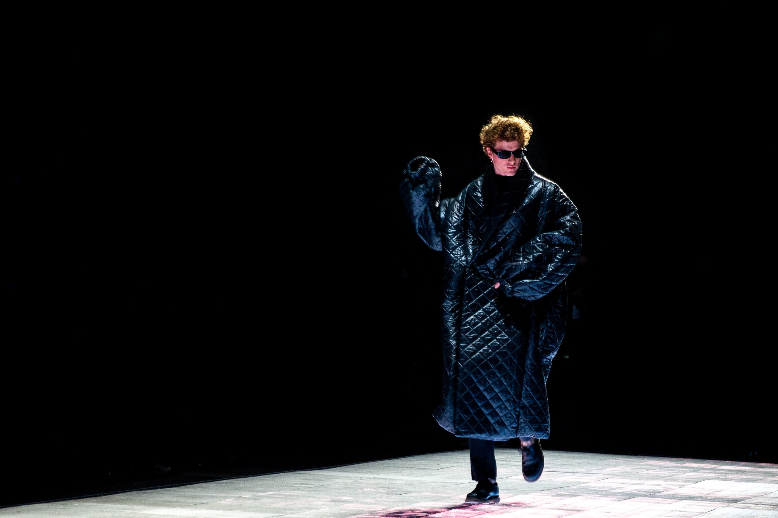 A male model dancing moment during the runway show at Rome Fashion Week.