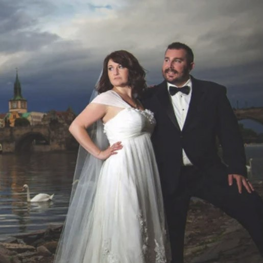 Dramatic portrait of a bride & groom from Indiana as they pose for a stylish portrait near the Vltava River in Prague. 