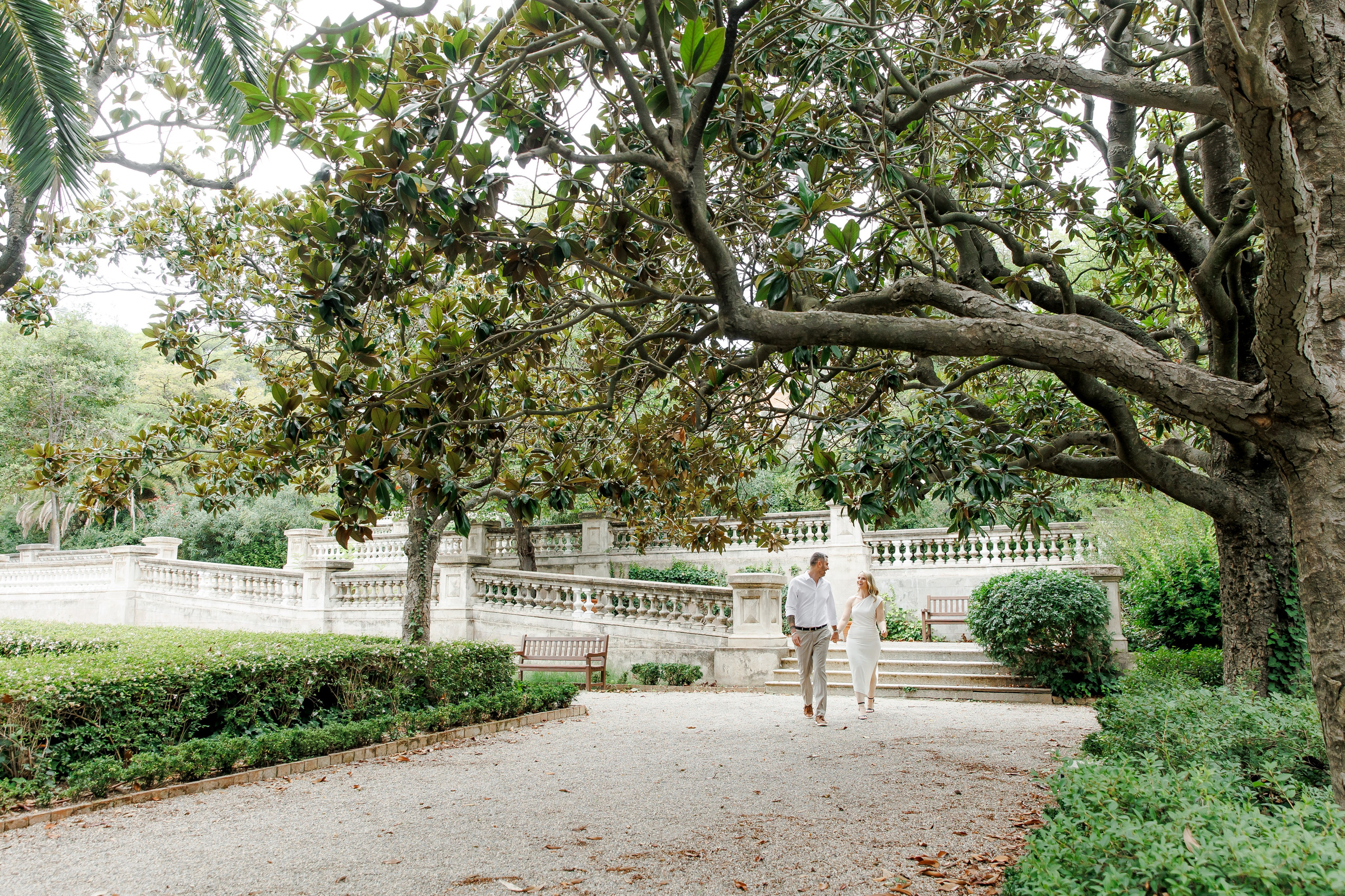A couple walks among beautiful gardens in Barcelona