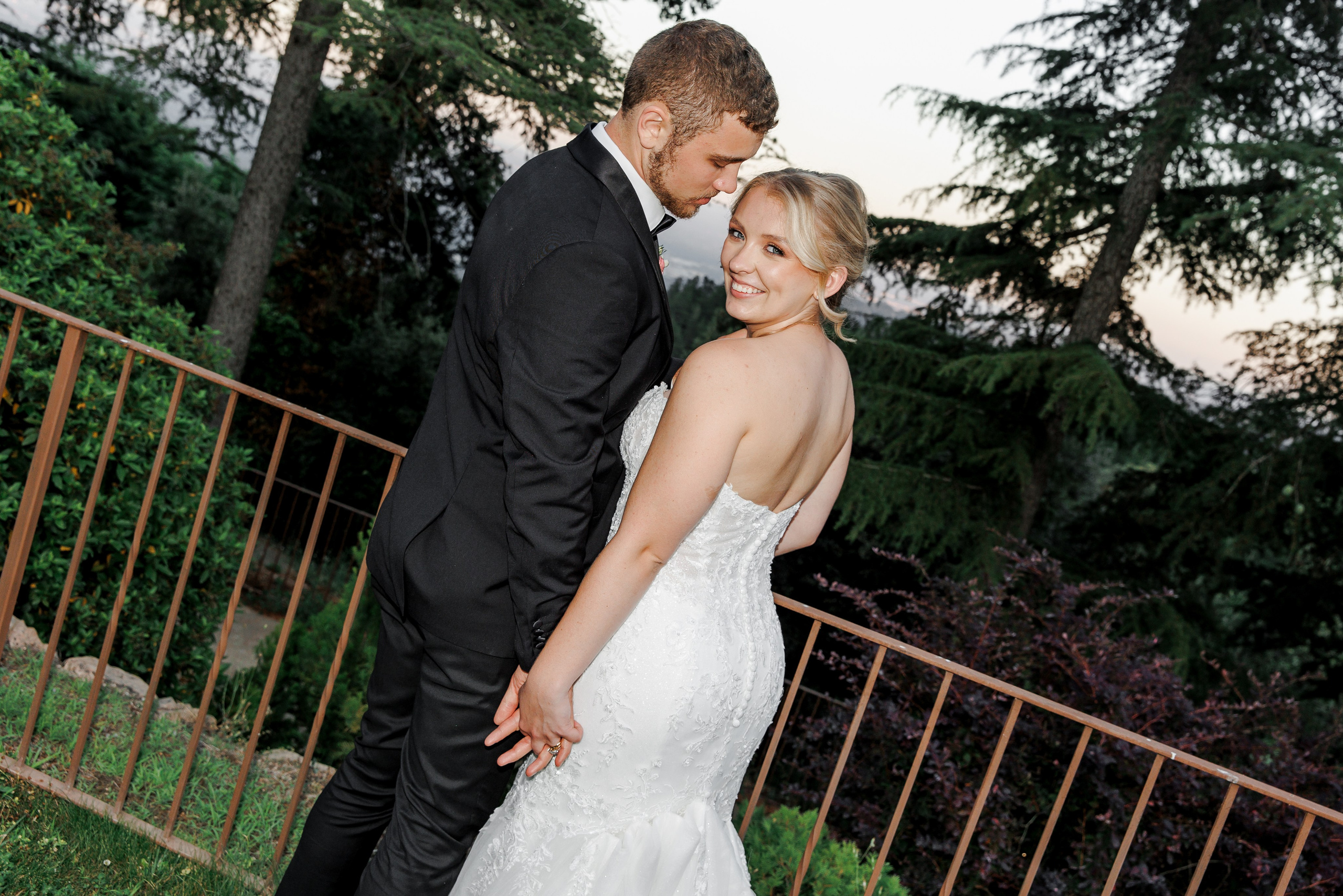 Bride and groom are enjoying the sunset after the dinner of their destination wedding in Barcelona, Spain