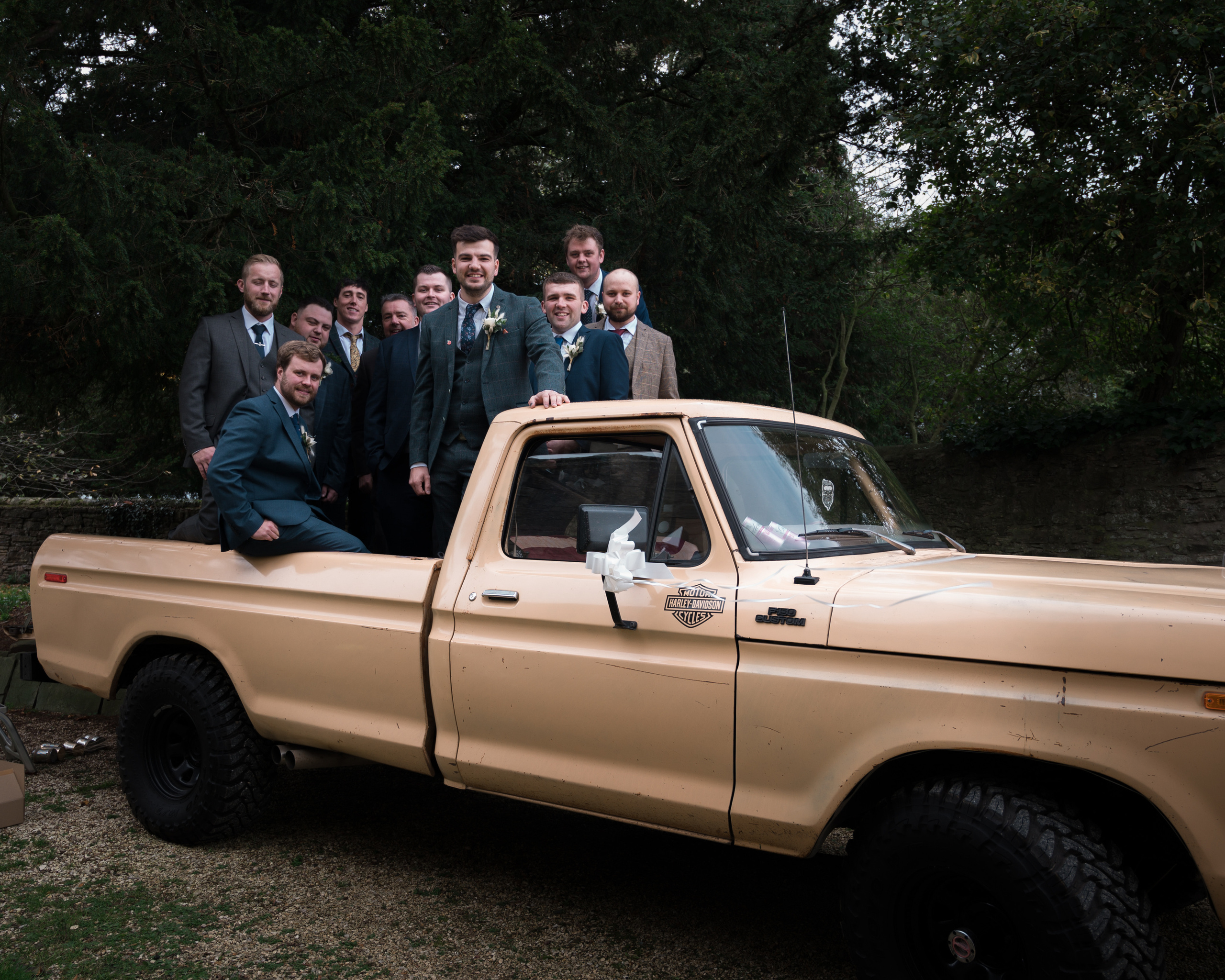 lads and groom posing in wedding truck 