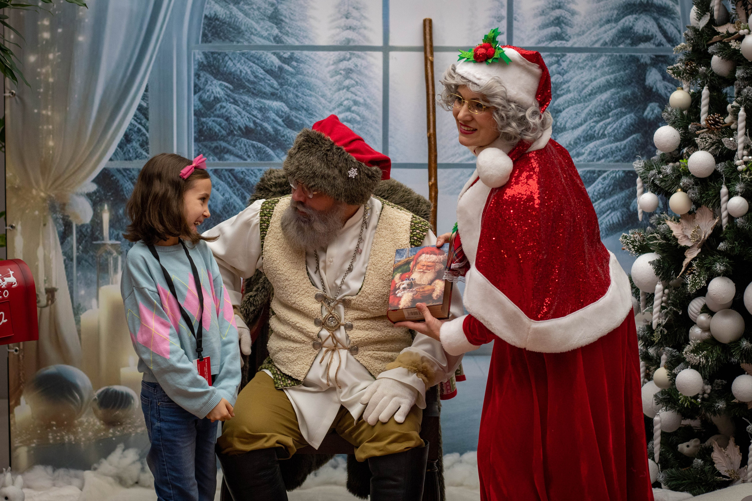 Santa Claus interacting with a fairy-dressed performer during a festive performance.