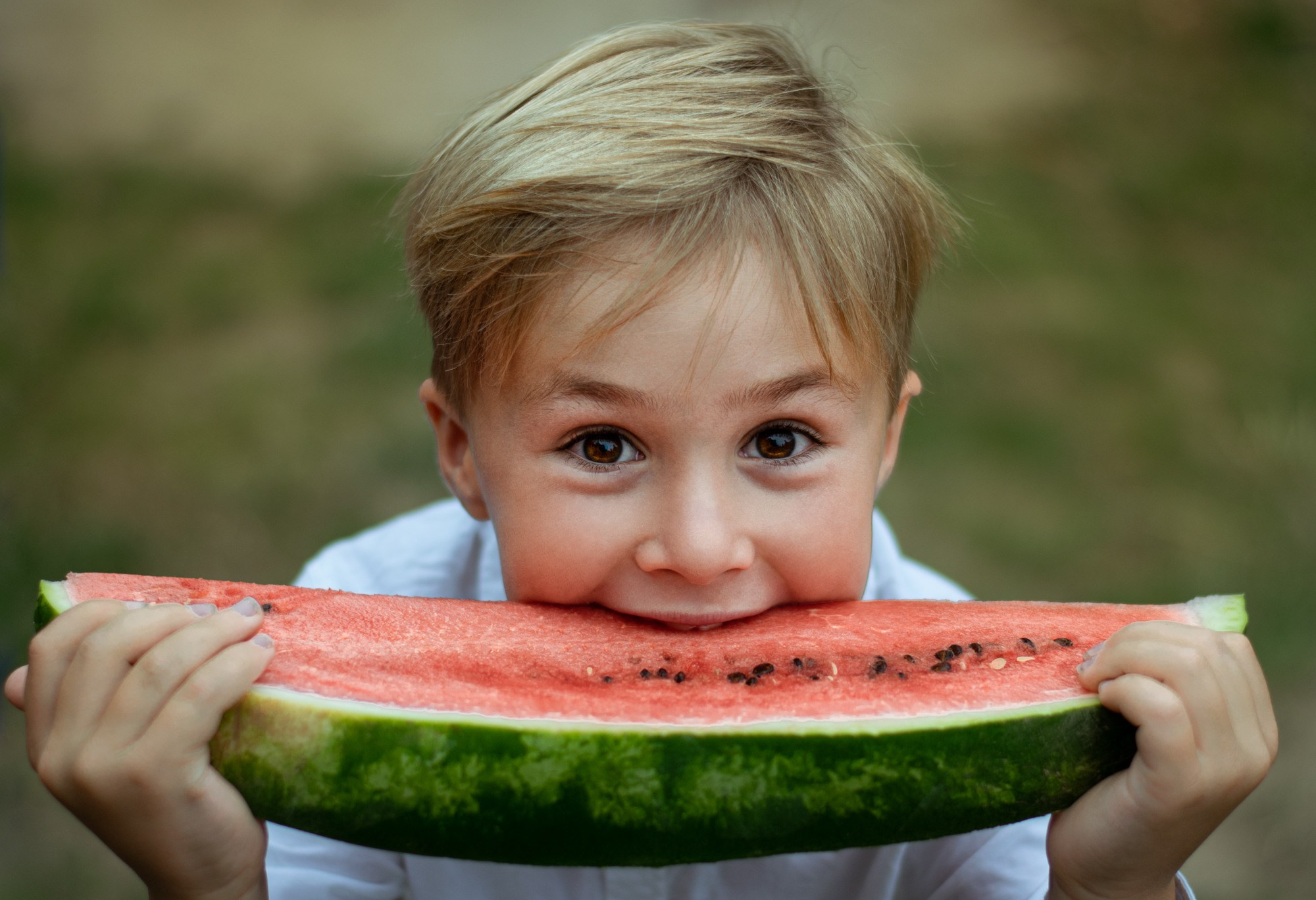 Мальчик ест арбуз и улыбается — летняя детская фотосессия, яркие фотографии детей