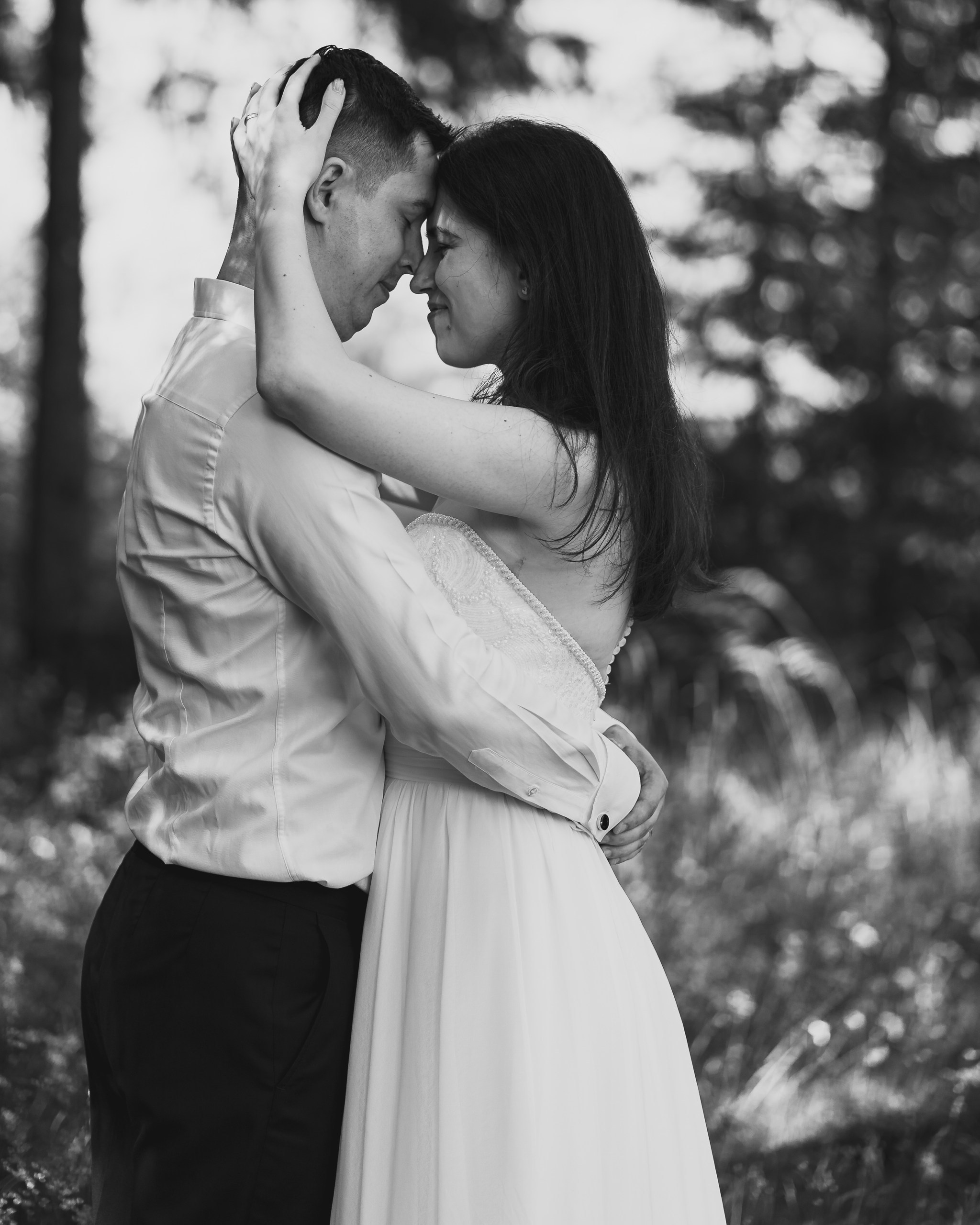 Moment emoționant între miri în ziua nunții, surprins într-un cadru natural și romantic, la Lacul Bolboci. Fotografie de nuntă profesională, editată artistic pentru a evidenția emoția și eleganța evenimentului.