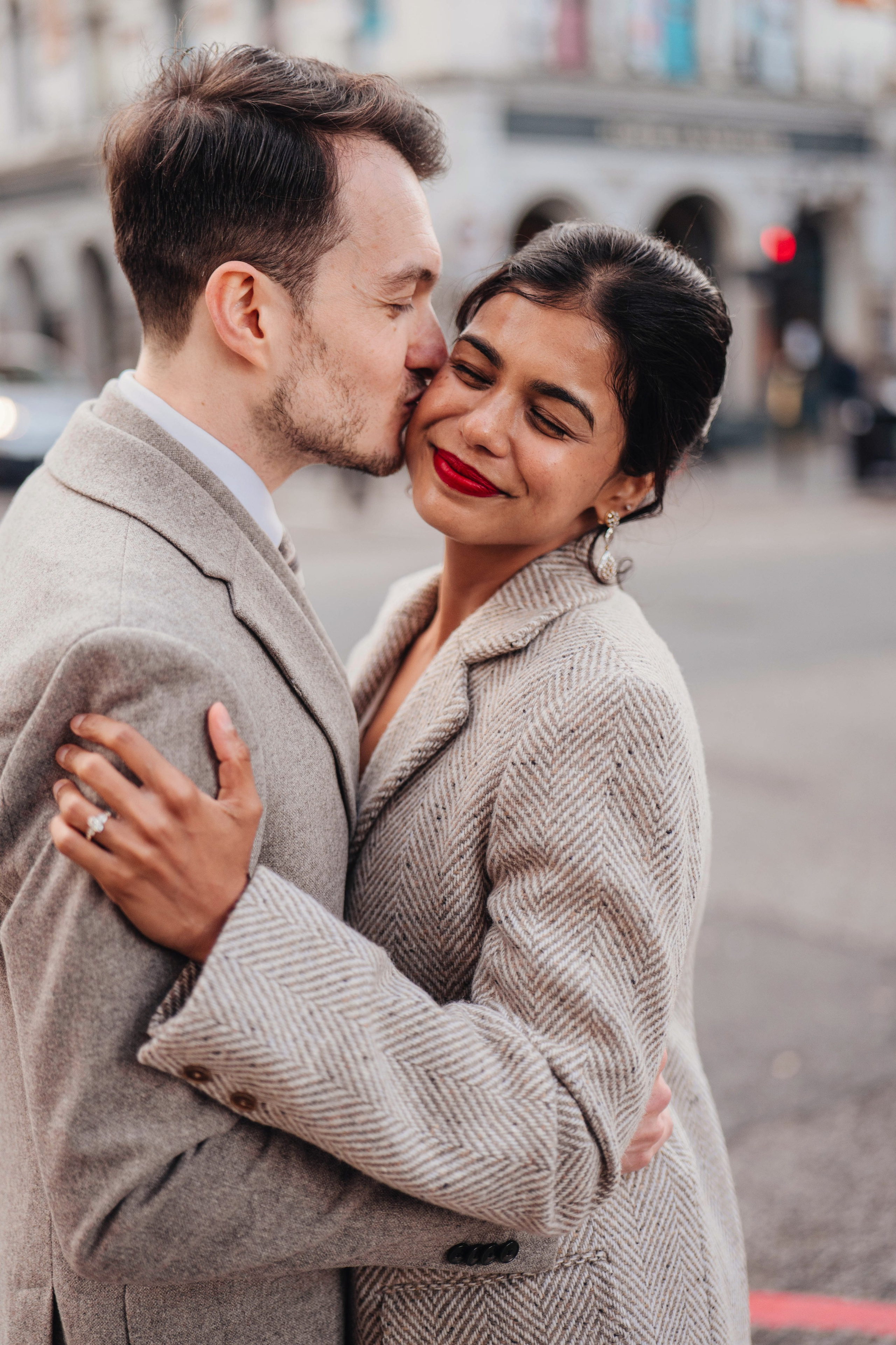 Wedding in Islington town hall, kissing couple from the back on the road crossing